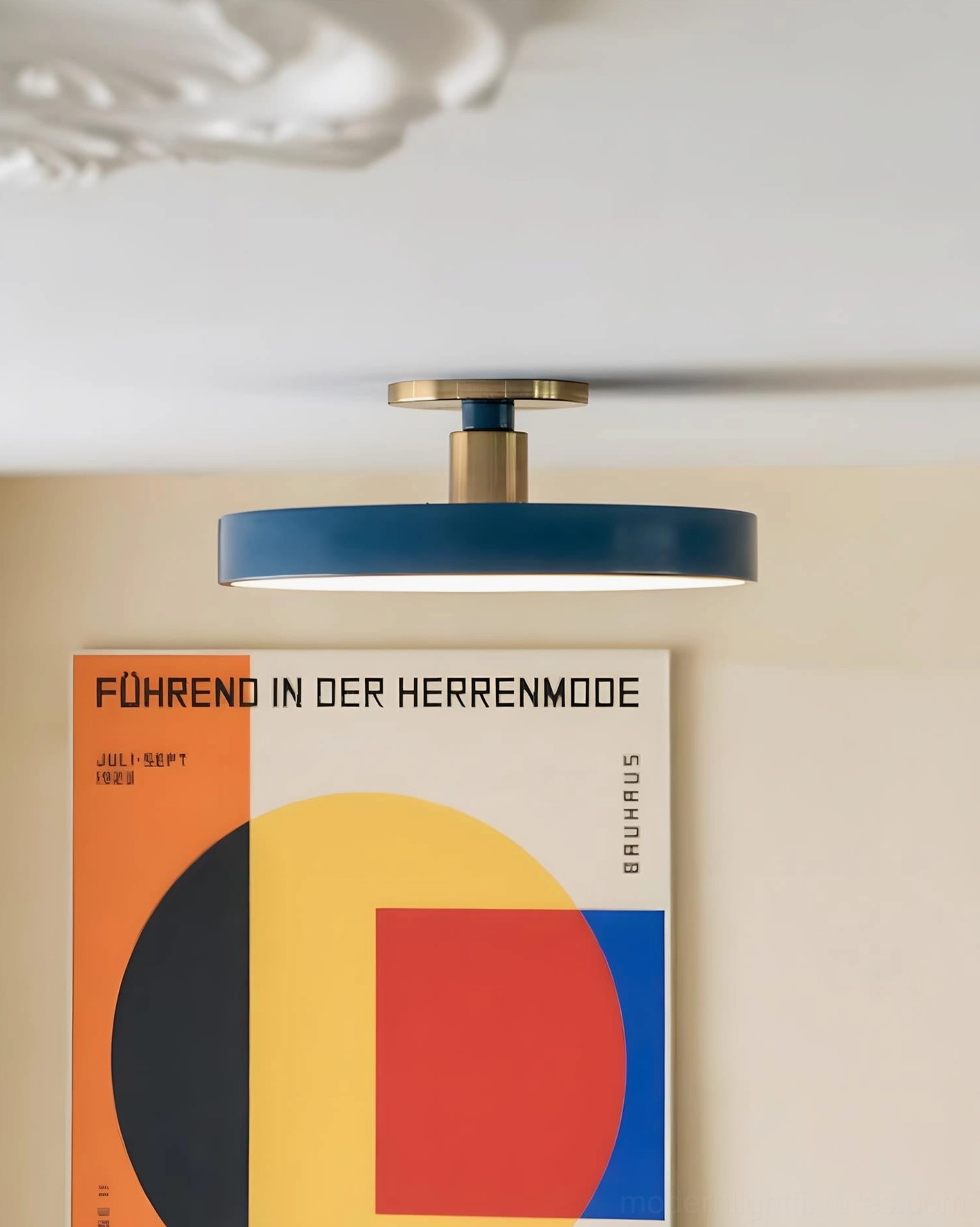 Minimalist flush mount ceiling lamp with navy blue shade and brass base in modern interior