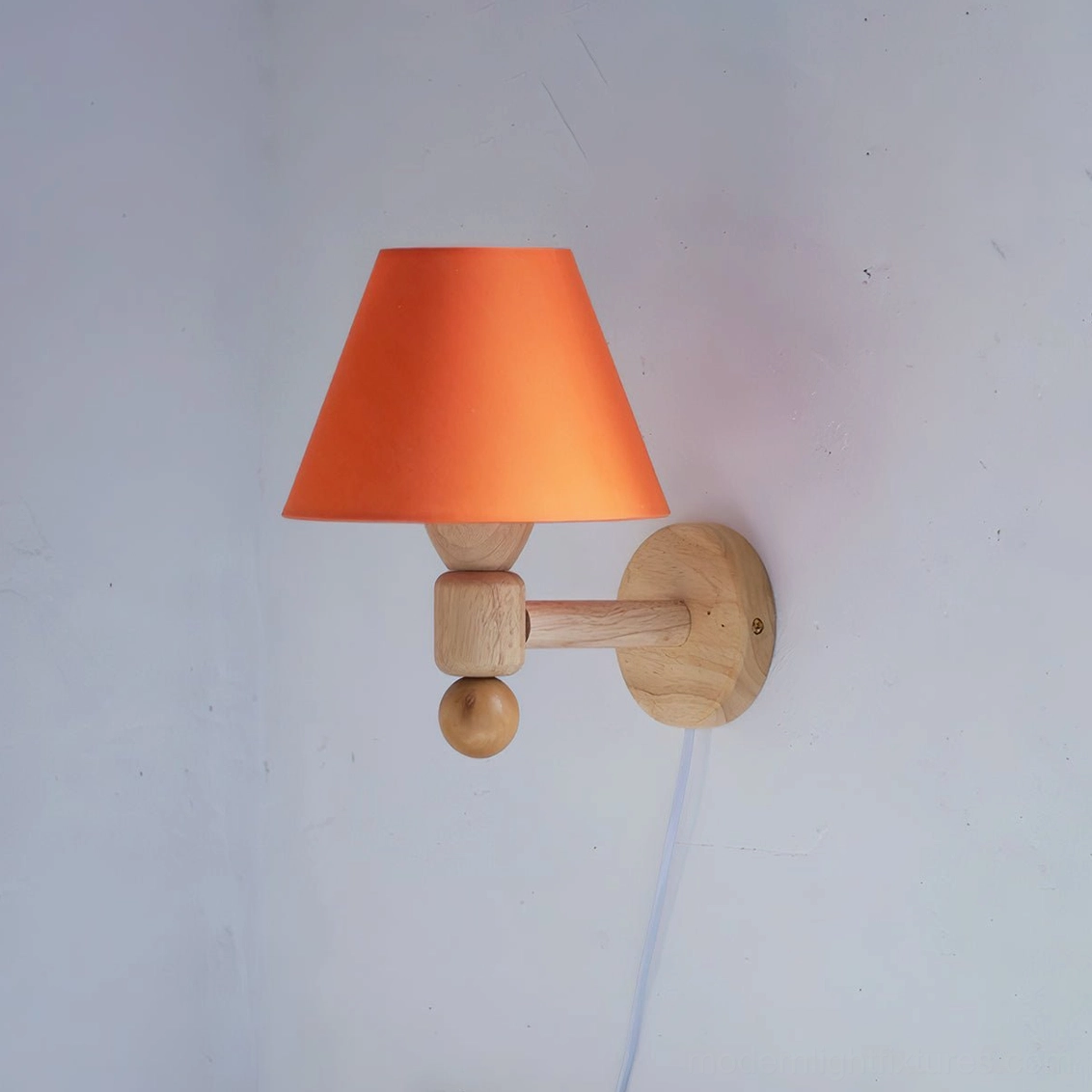 Hardwired minimalist wall sconce featuring bold orange conical shade attached to natural wood geometric bracket