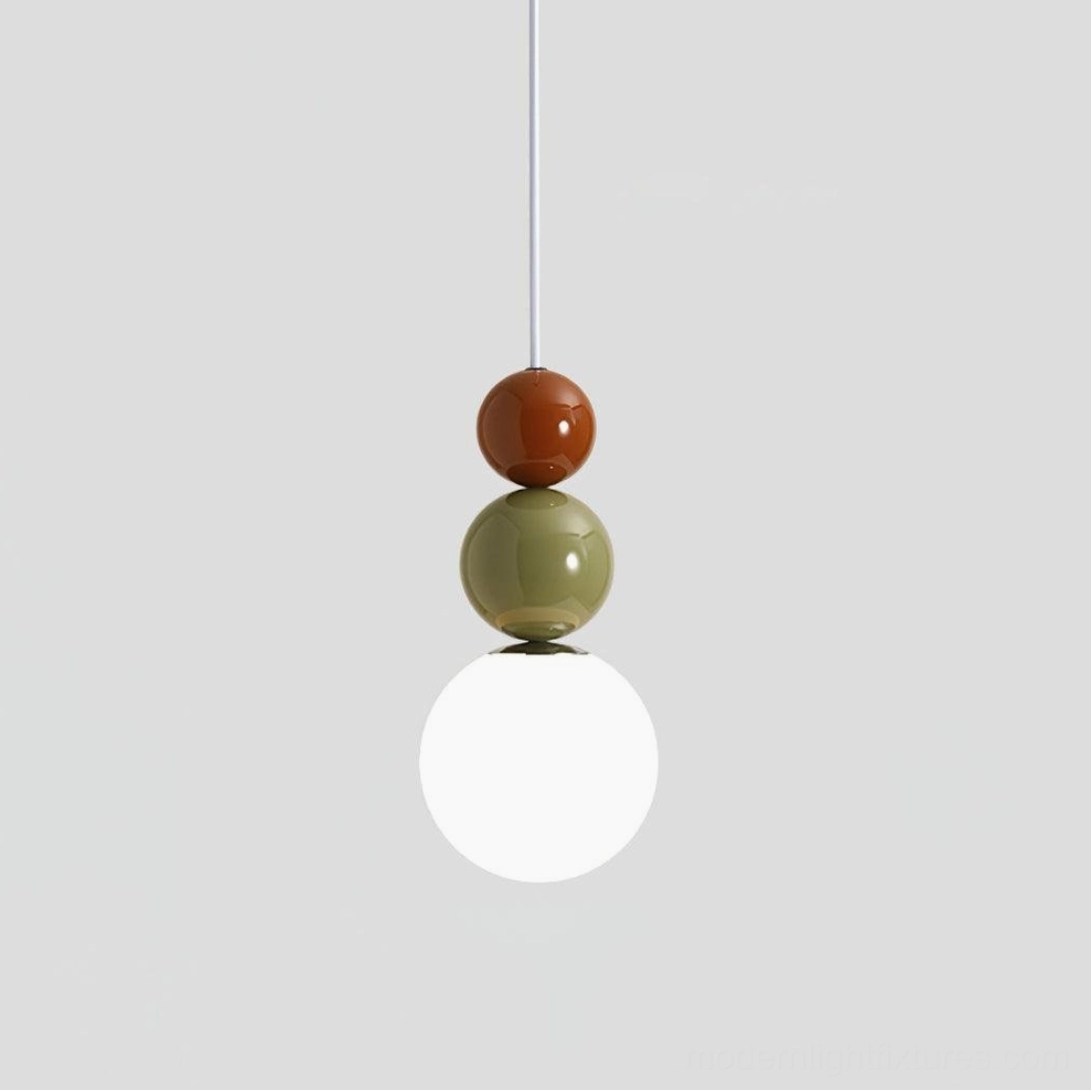 Bright minimalist white kitchen featuring uniform three-sphere pendant lights over kitchen counter