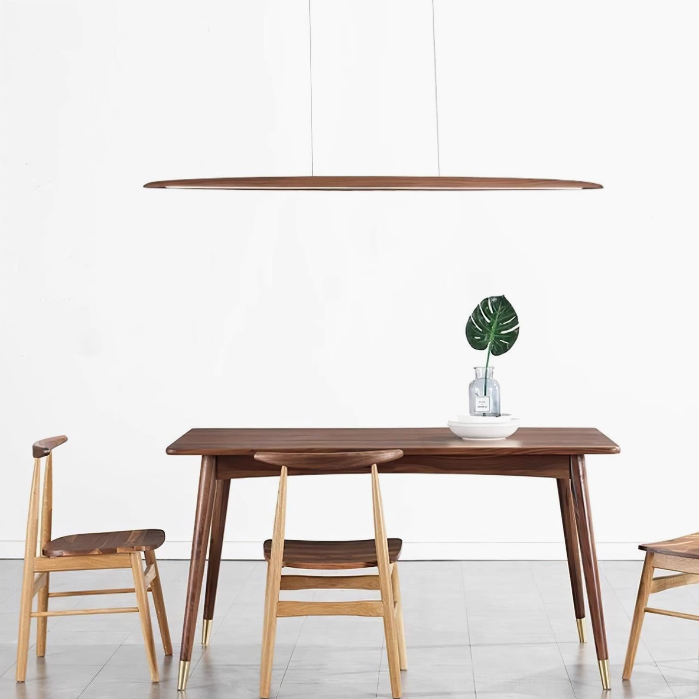 Sleek linear LED chandelier pendant light with natural light wood finish and potted plant decor