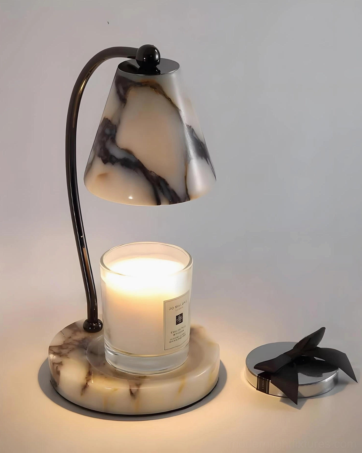 Modern table lamp candle warmer with marble and metal construction in minimalist interior setting