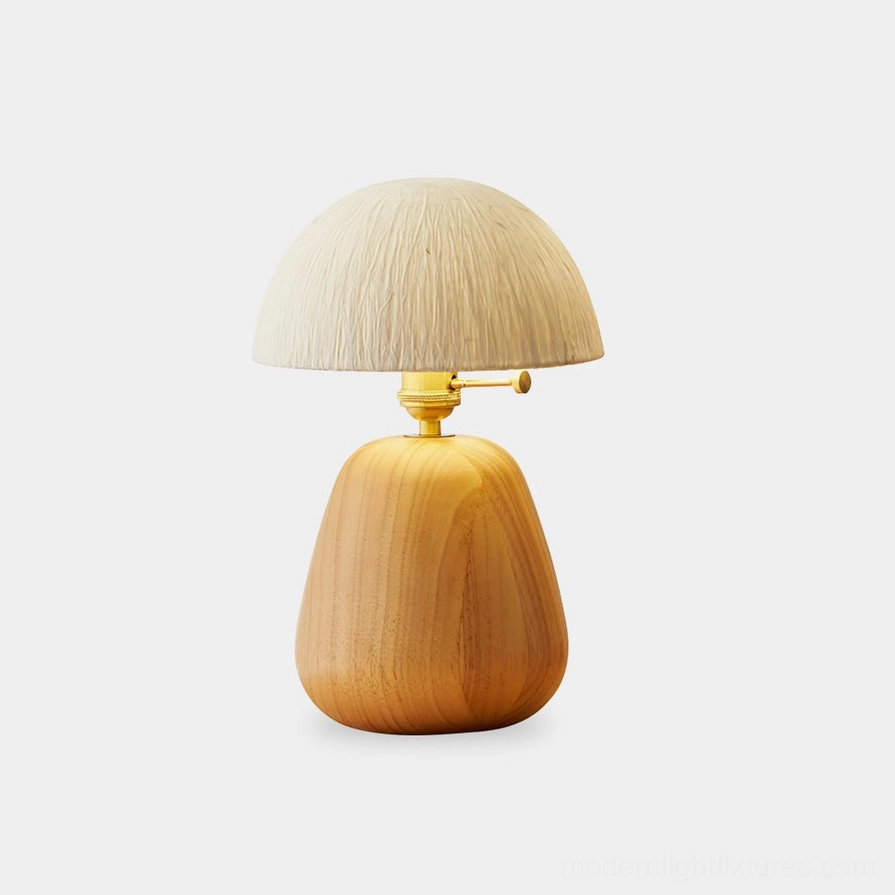 Minimalist mushroom-shaped oak wood table lamp with woven rice paper shade and gold metal hardware on white background