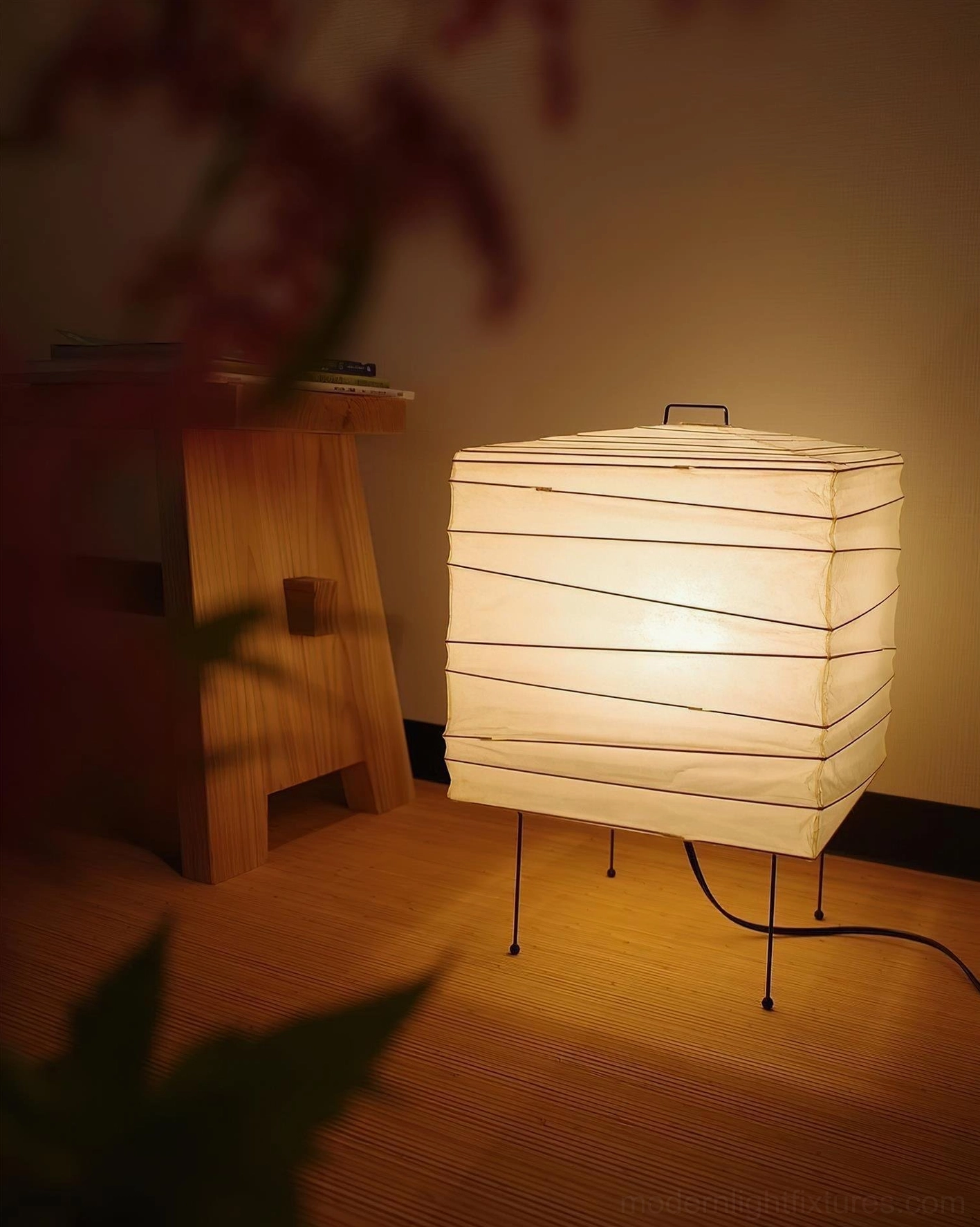 Minimalist wabi-sabi inspired paper cube lamp creating atmospheric lighting in contemporary living room