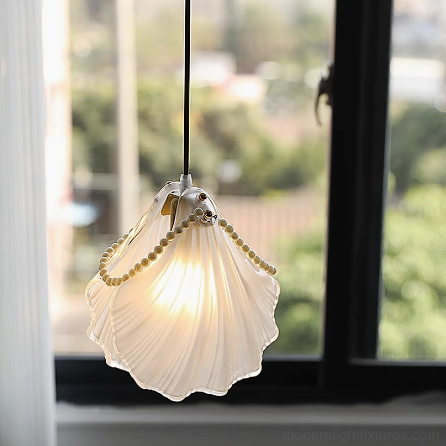 Minimalist pearl shell pendant light fixture with clean lines and sophisticated glass design