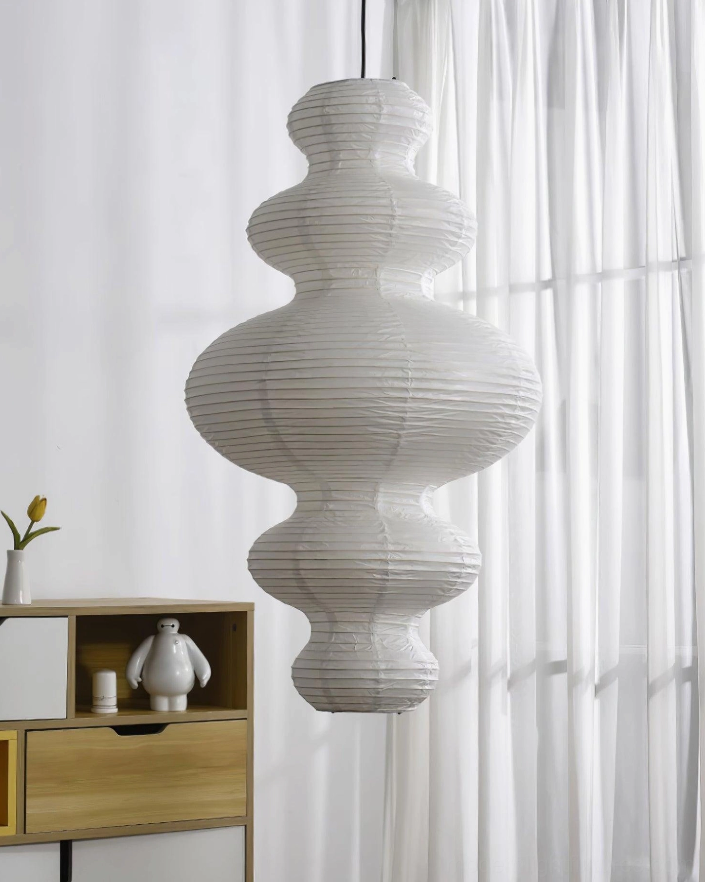 Modern off-white sculptural pendant light in minimalist interior design with natural materials