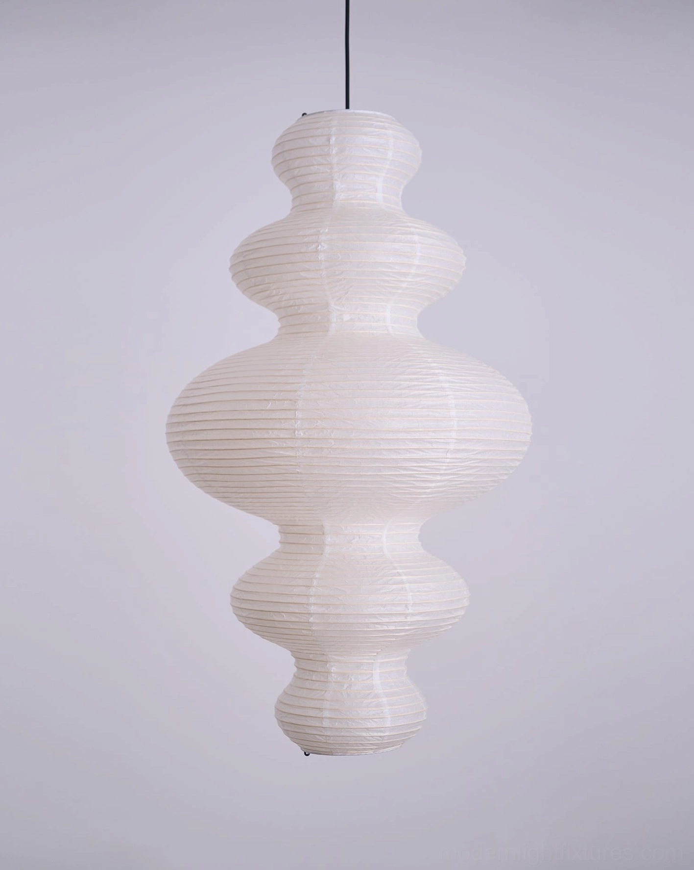 Minimalist white sculptural pendant light mounted in corner bedroom creating ambient bedroom lighting