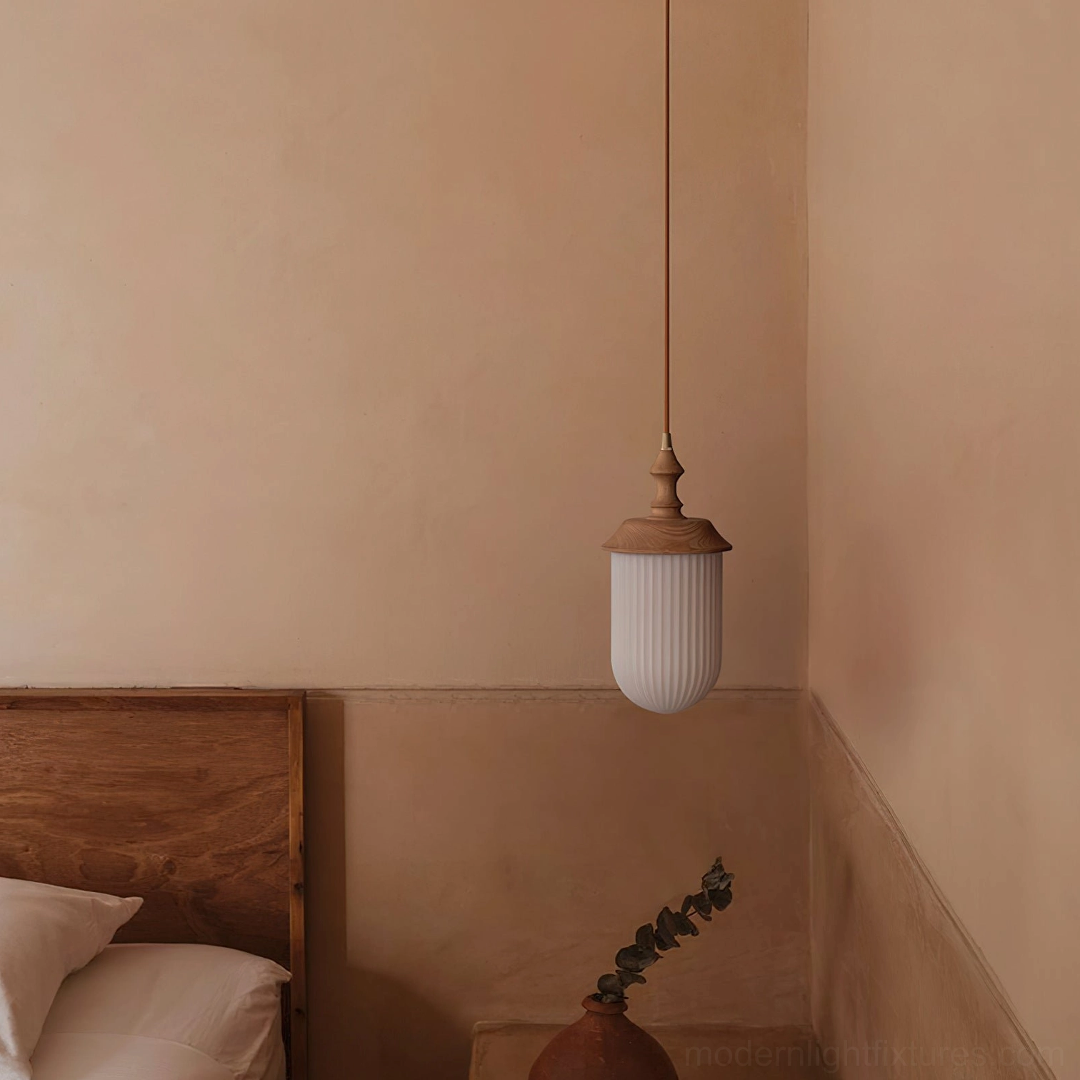 Minimalist pendant light suspended in small bedroom corner with warm neutral wall and cozy ambiance