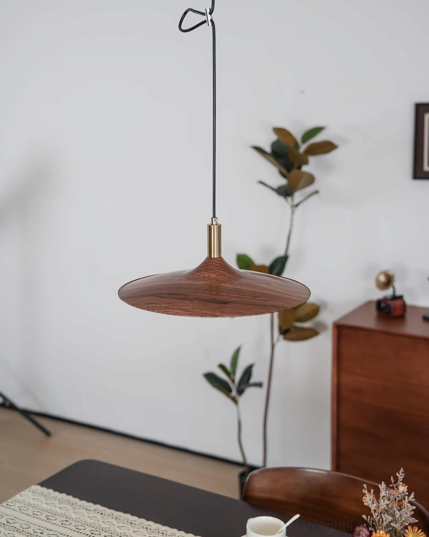 Minimalist dining nook with nano adjustable pendant light and warm wood shade