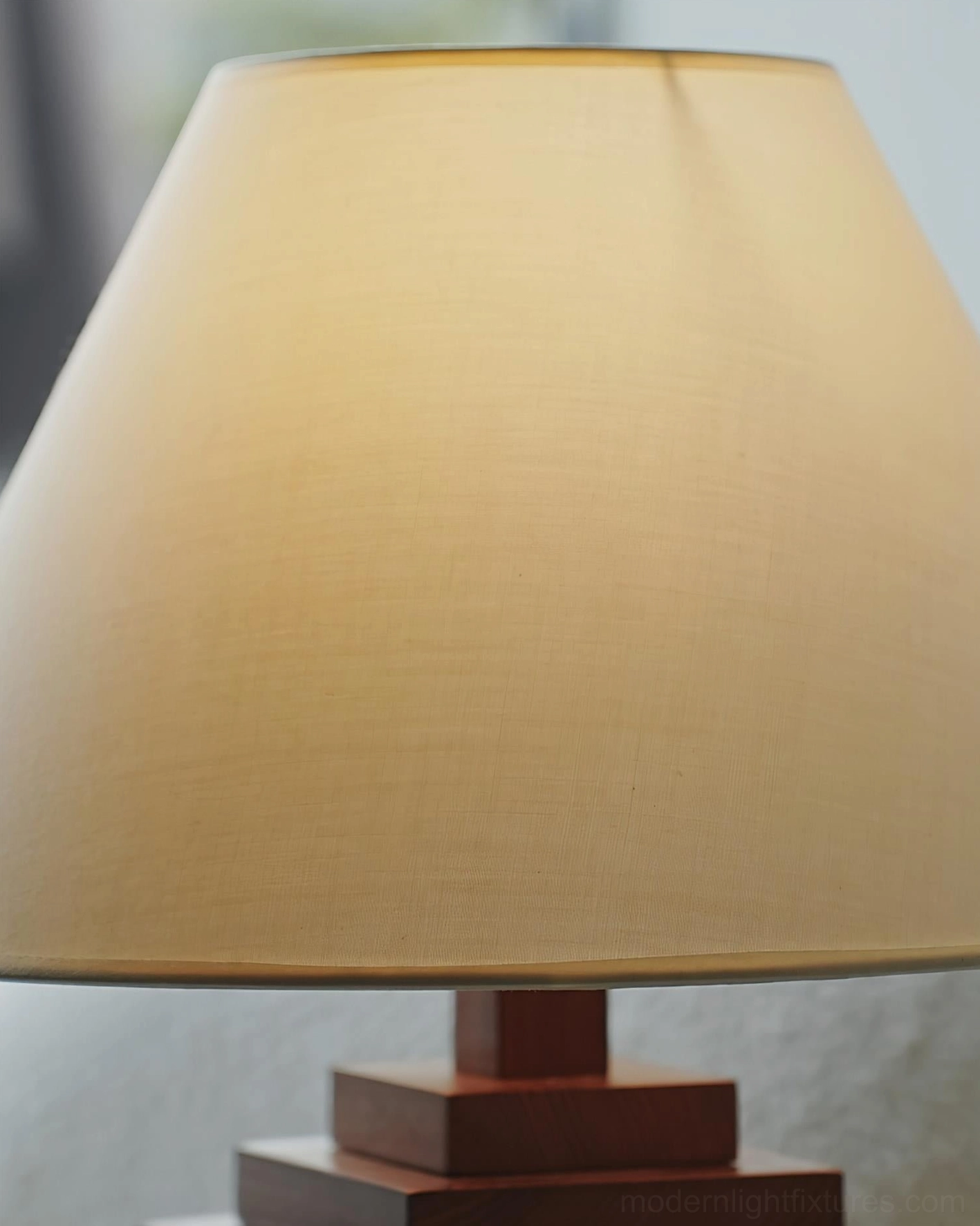 Modern stacked wooden tower table lamp creating focal point in minimalist room setting with neutral color palette