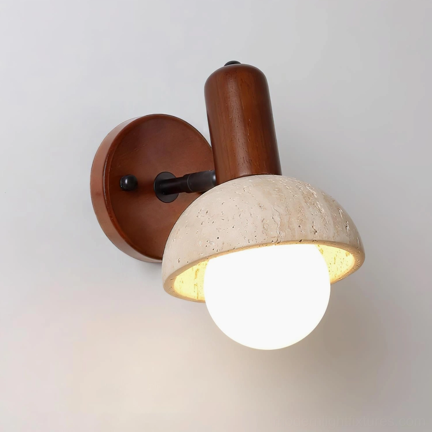 Minimalist travertine wall sconce with dark wood base and black fixture accents
