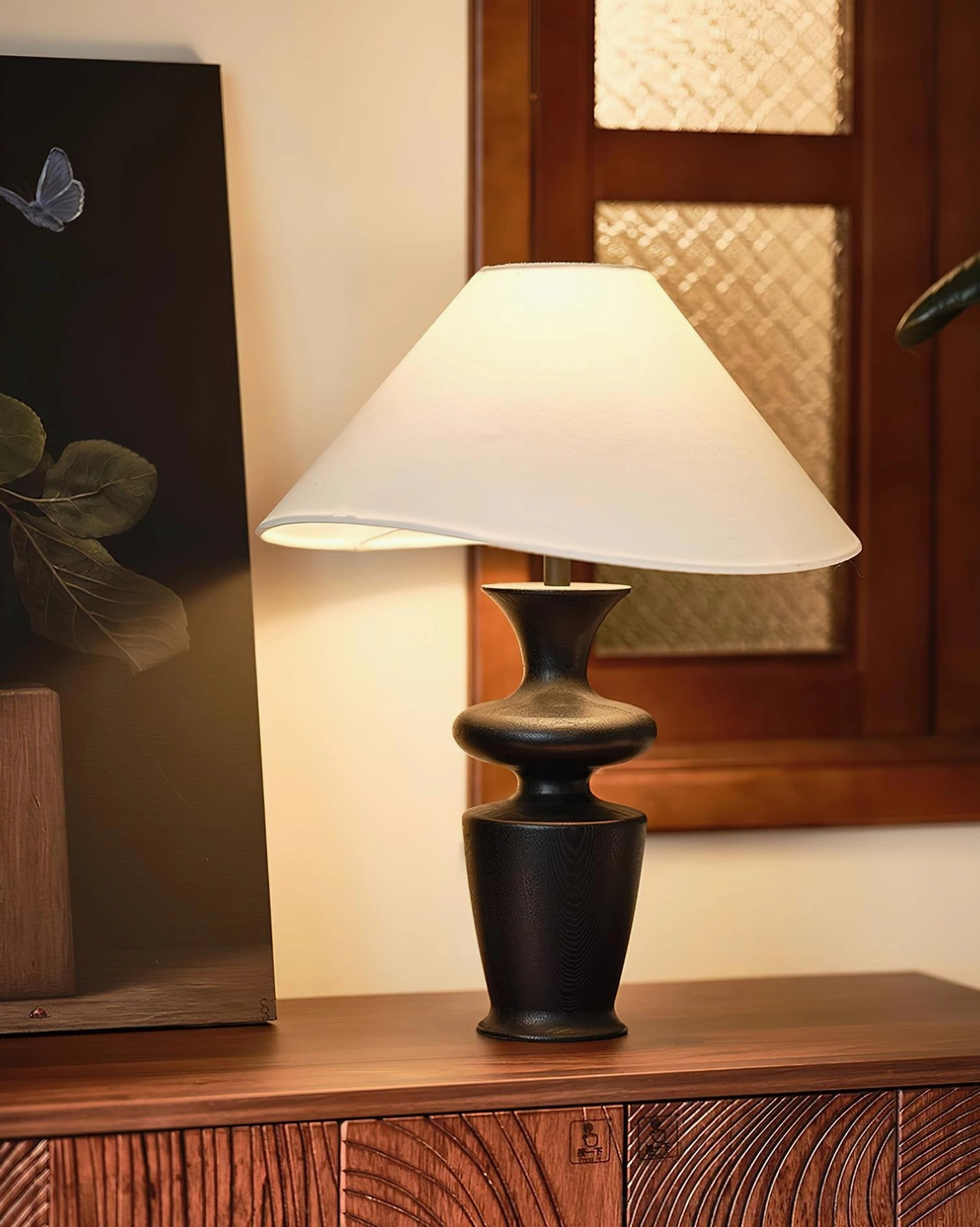 Modern minimalist table lamp in home office setting, providing focused ambient lighting for reading and work spaces
