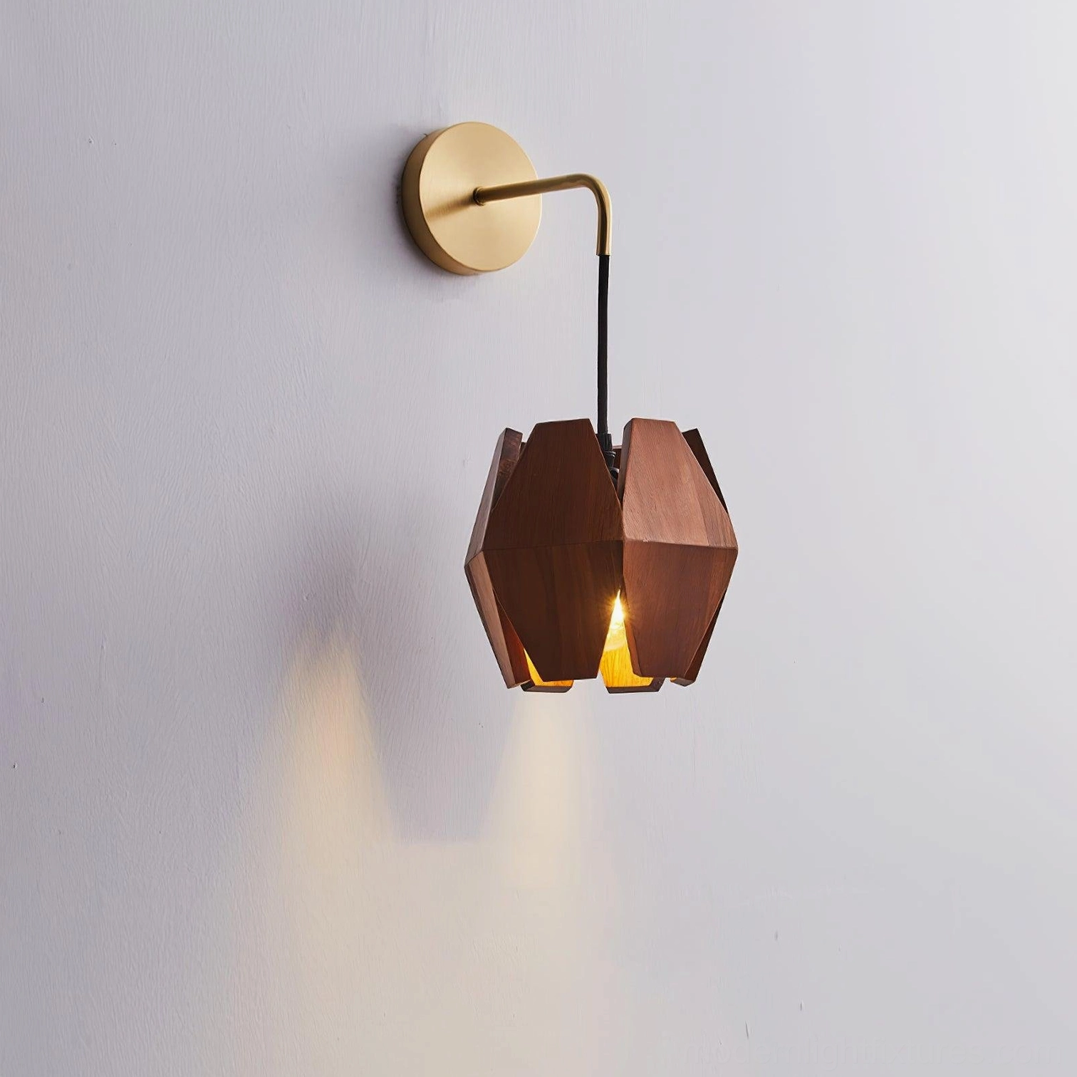 Minimalist wood wall sconce sculptural facets light shadow play artistic installation