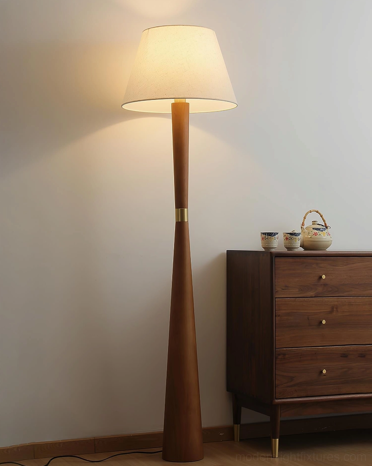 Minimalist wooden floor lamp with fabric shade creating ambient light in Scandinavian home interior