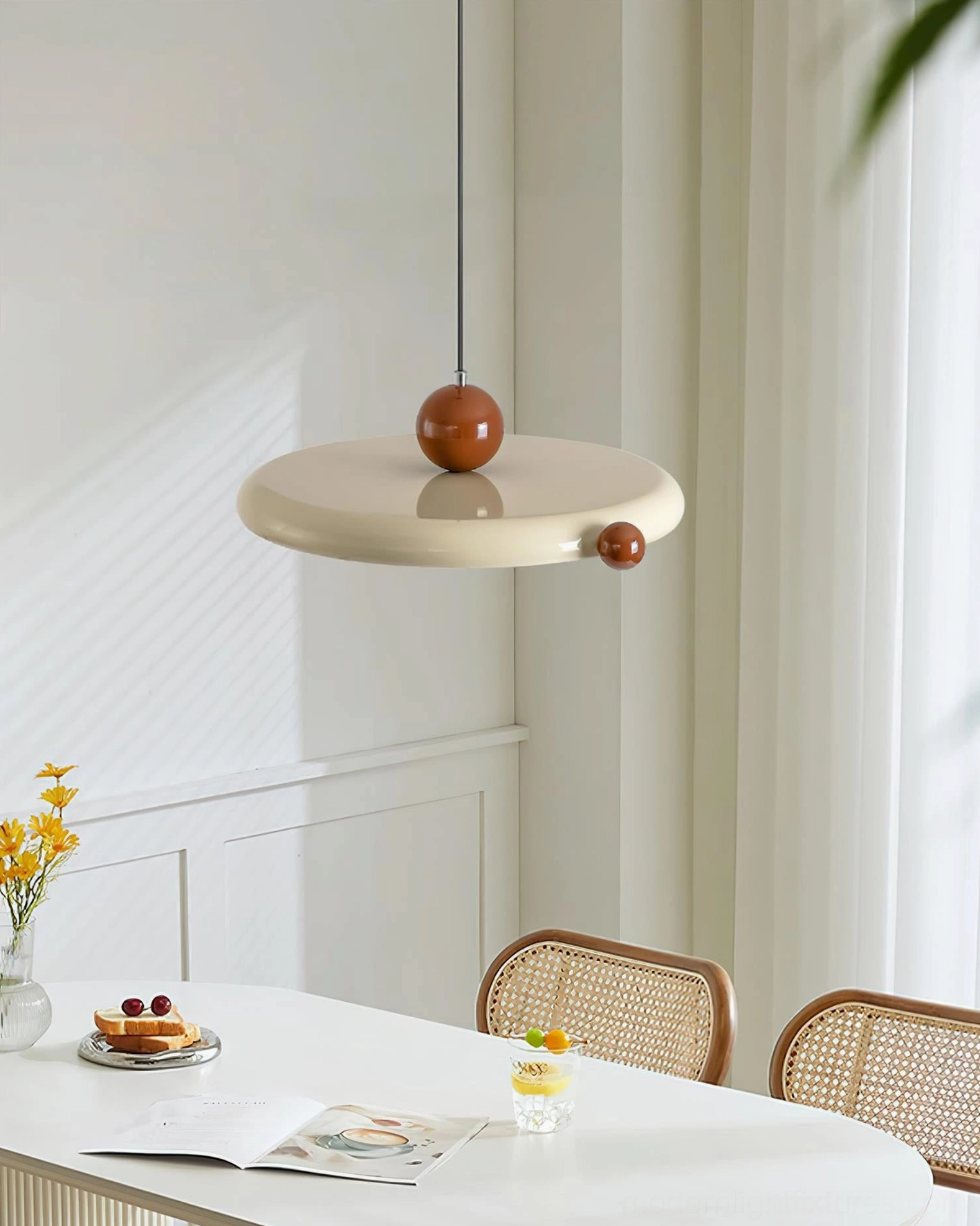 Minka modern pendant light in minimalist dining room with white wainscoting and botanical decor