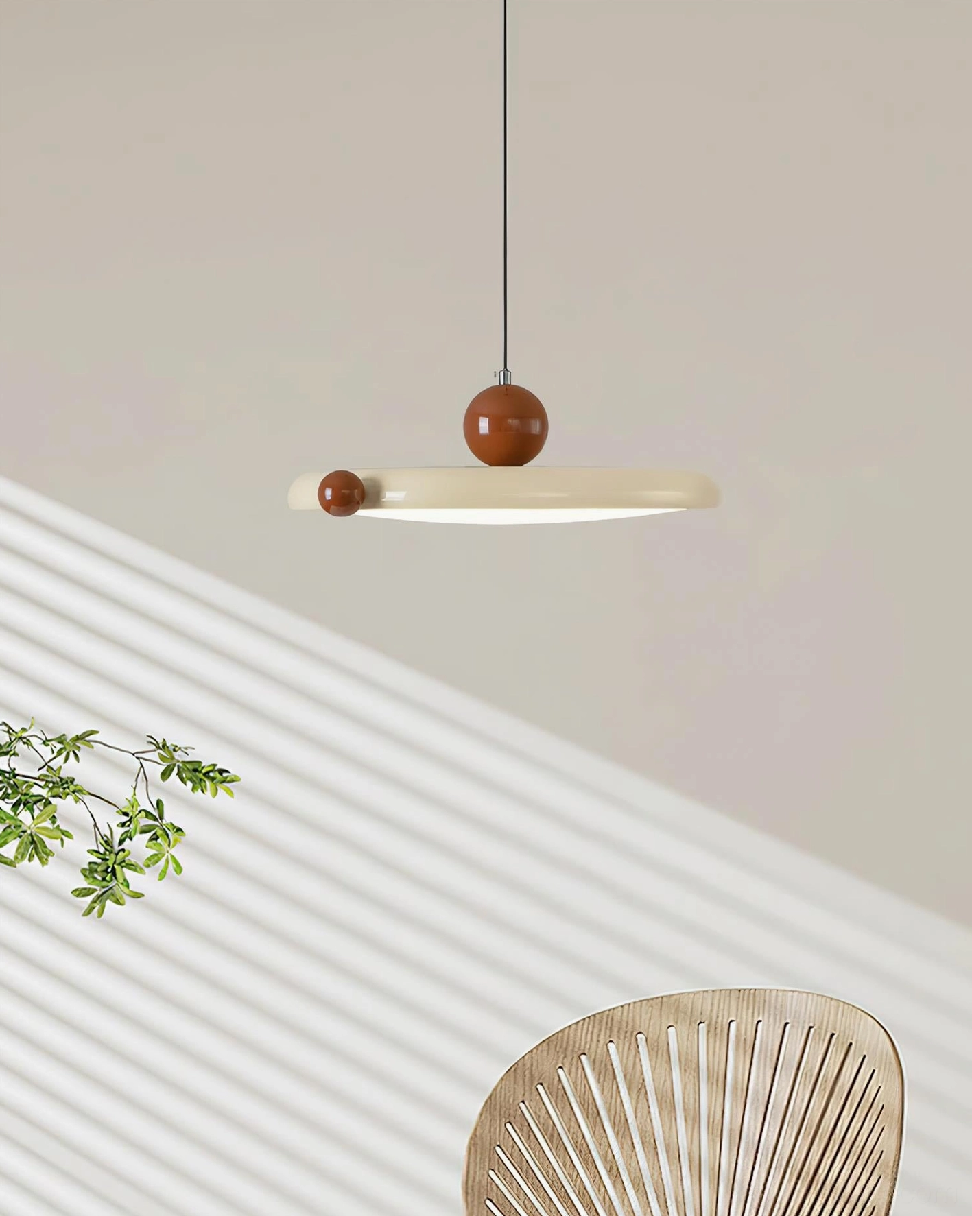 Minka acrylic pendant light in sunlit minimalist space with striped shadows and plant decor