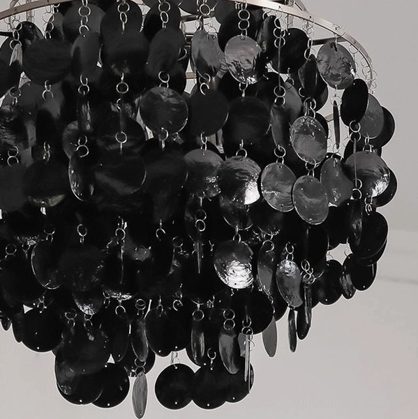 Mirelle tiered shell chandelier side angle view showing cascading disc layers and lighting diffusion
