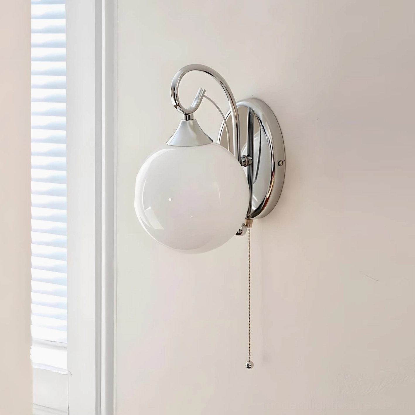 White frosted glass globe wall sconce with polished chrome curved arm, studio front view with window lighting
