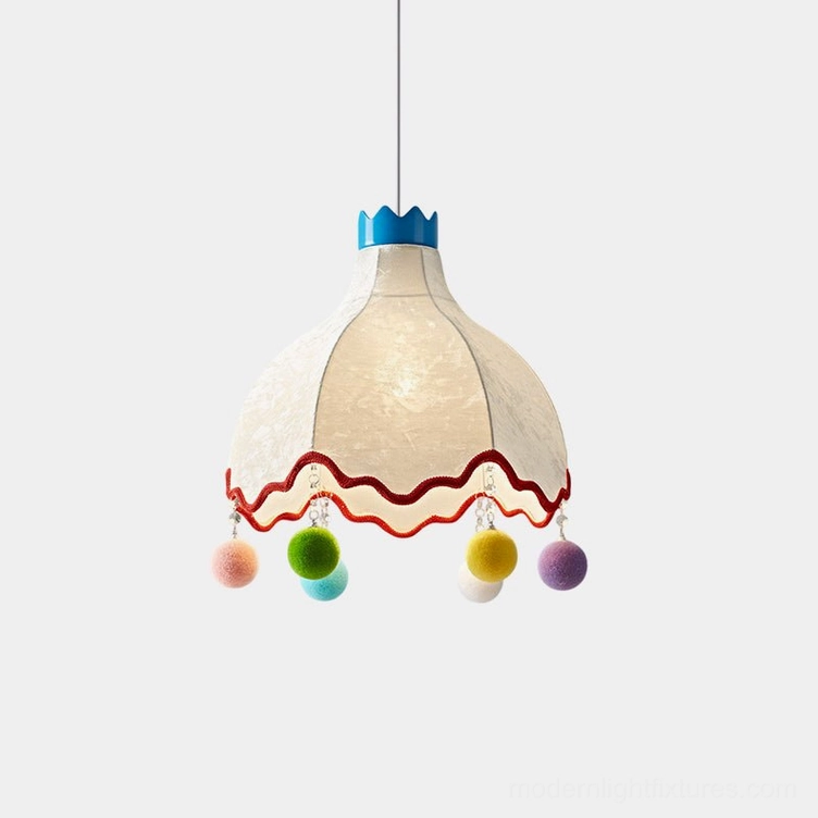 Mireo whimsical pendant light with blue crown finial, off-white fabric shade, red scalloped trim, and multicolor pom-pom decorations - front studio view