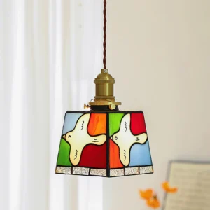 Stained glass pendant light with twisted cord and brass hardware indoor display