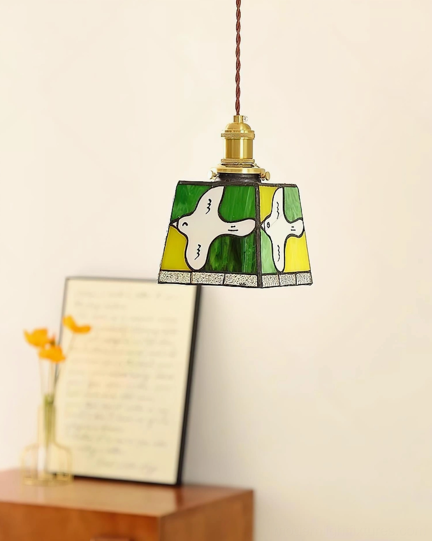Miroa pendant lamp hung over wooden furniture vibrant glass tones lighting