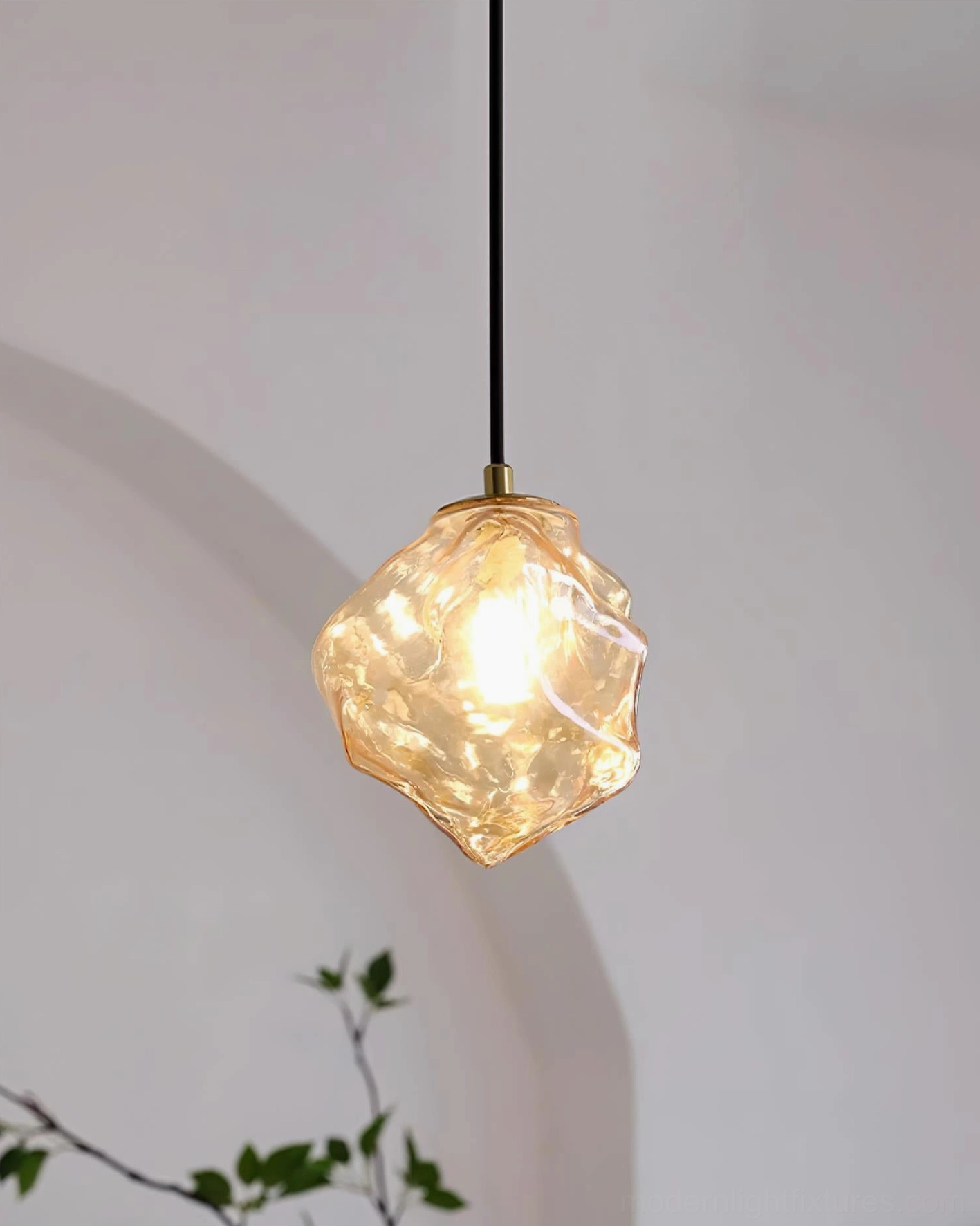 Mirza amber irregular glass pendant light emitting warm glow, artisanal craftsmanship with organic form design