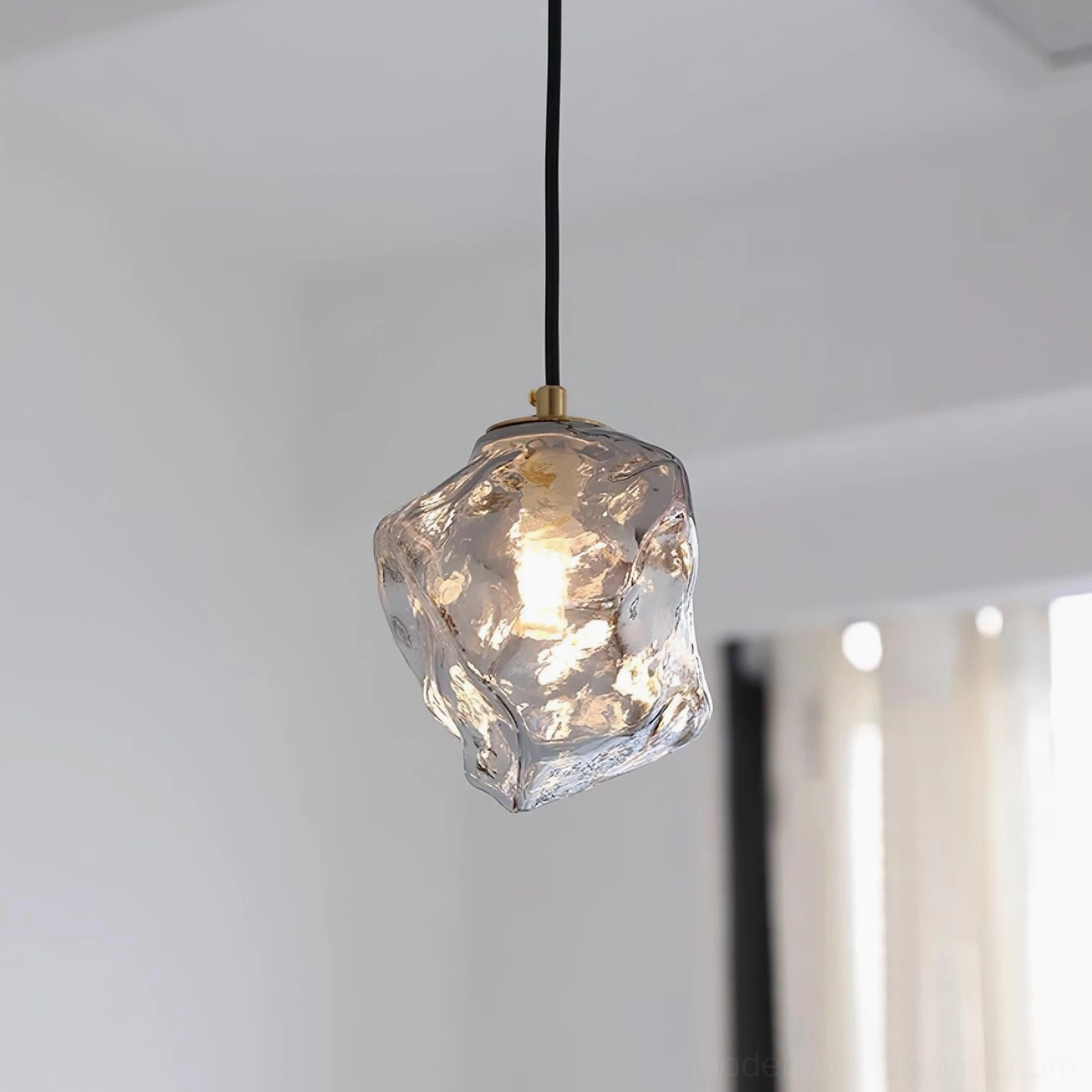 Mirza clear textured glass pendant lamp illuminated warm light through window, artistic light diffusion from irregular glass form