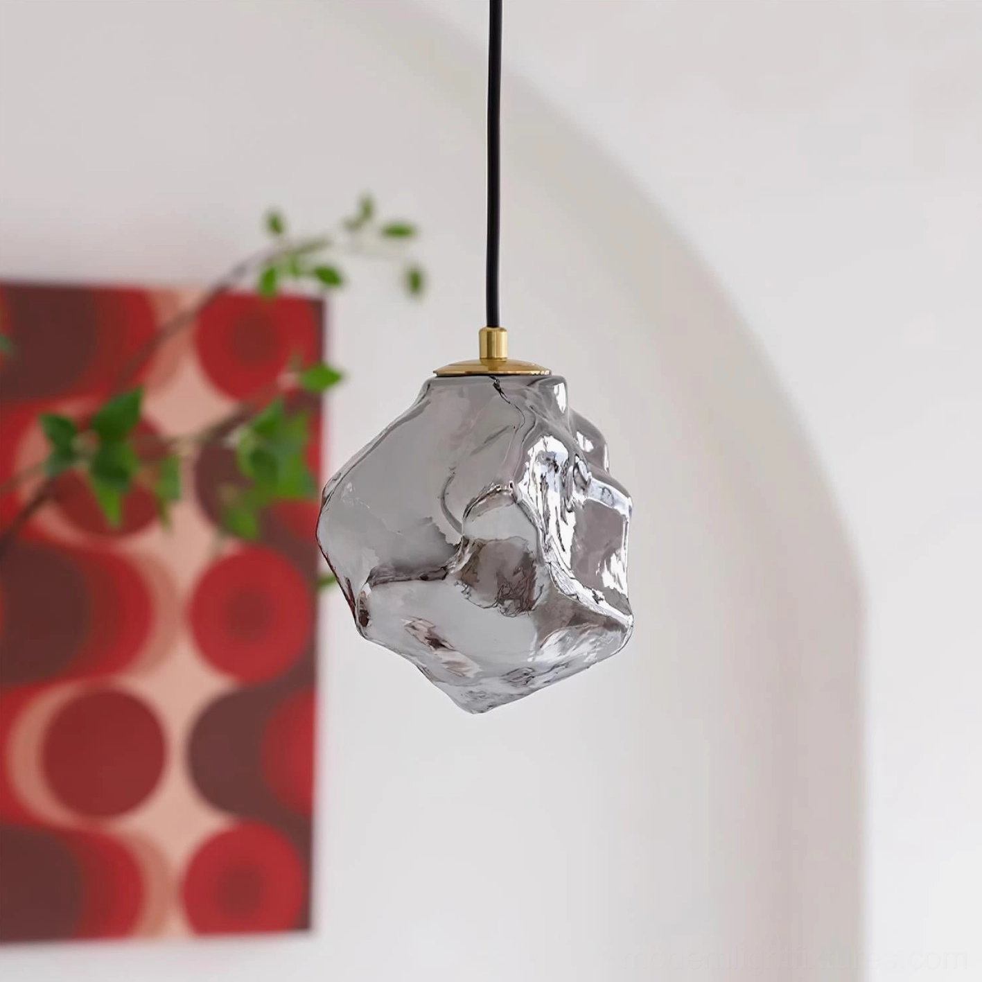 Mirza pendant light side profile view showing irregular glass texture and brass metal accents in minimalist home environment