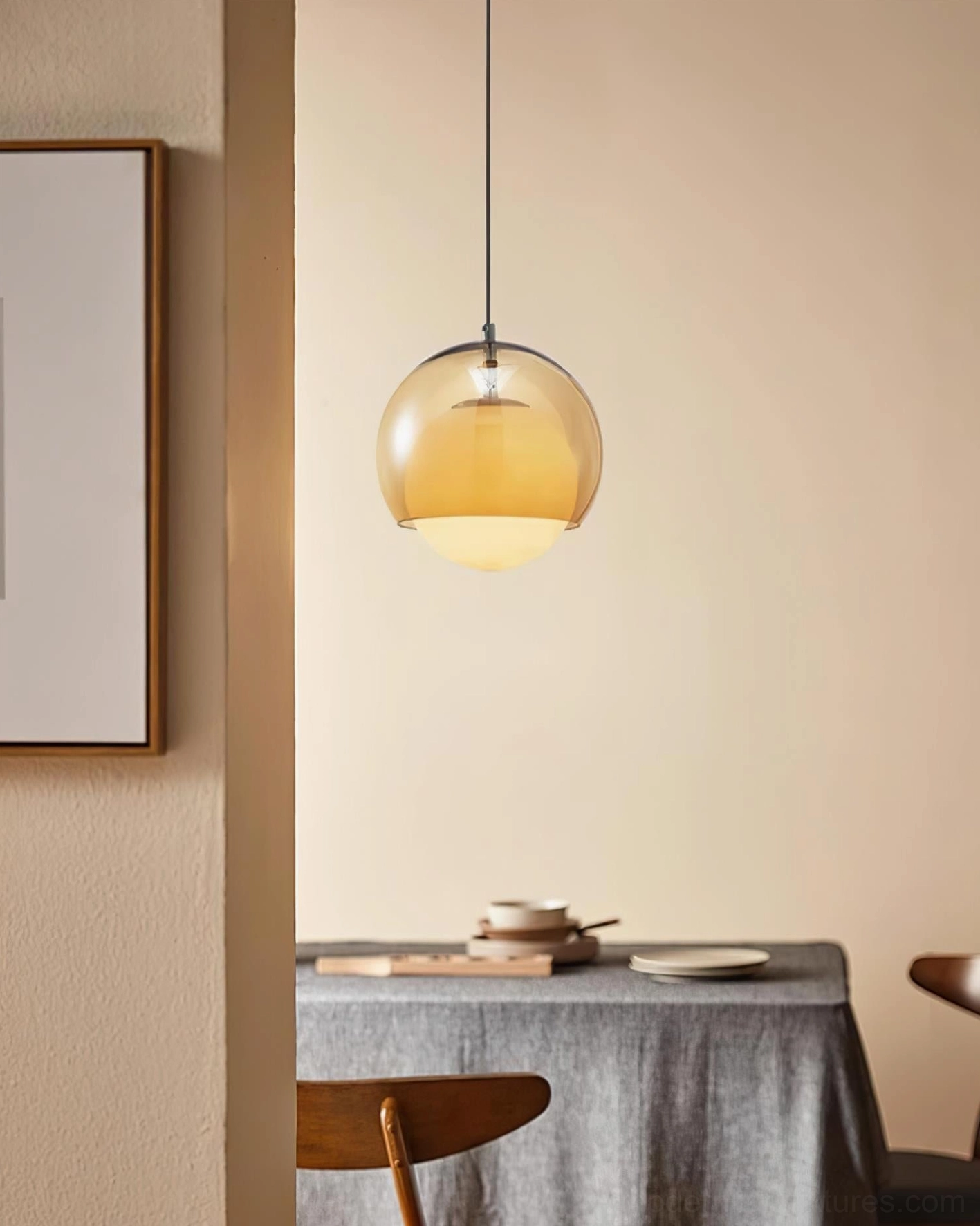 Warm amber light emitted from Misty cognac glass pendant creating cozy interior ambiance