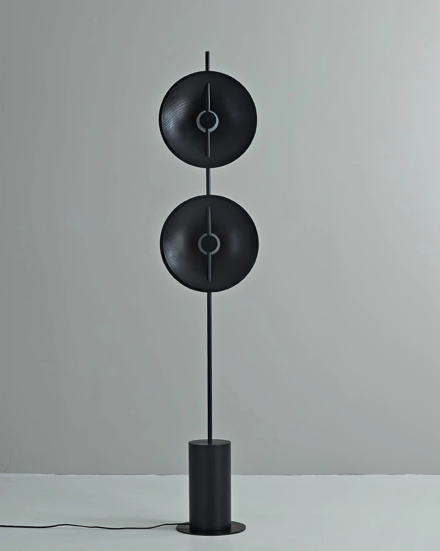Mito minimalist floor lamp with all-black design and matte finish on studio backdrop