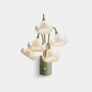 Mivella floral motion-sensor wall sconce with five ruffled white acrylic flower heads and sage green iron stem base on white studio background