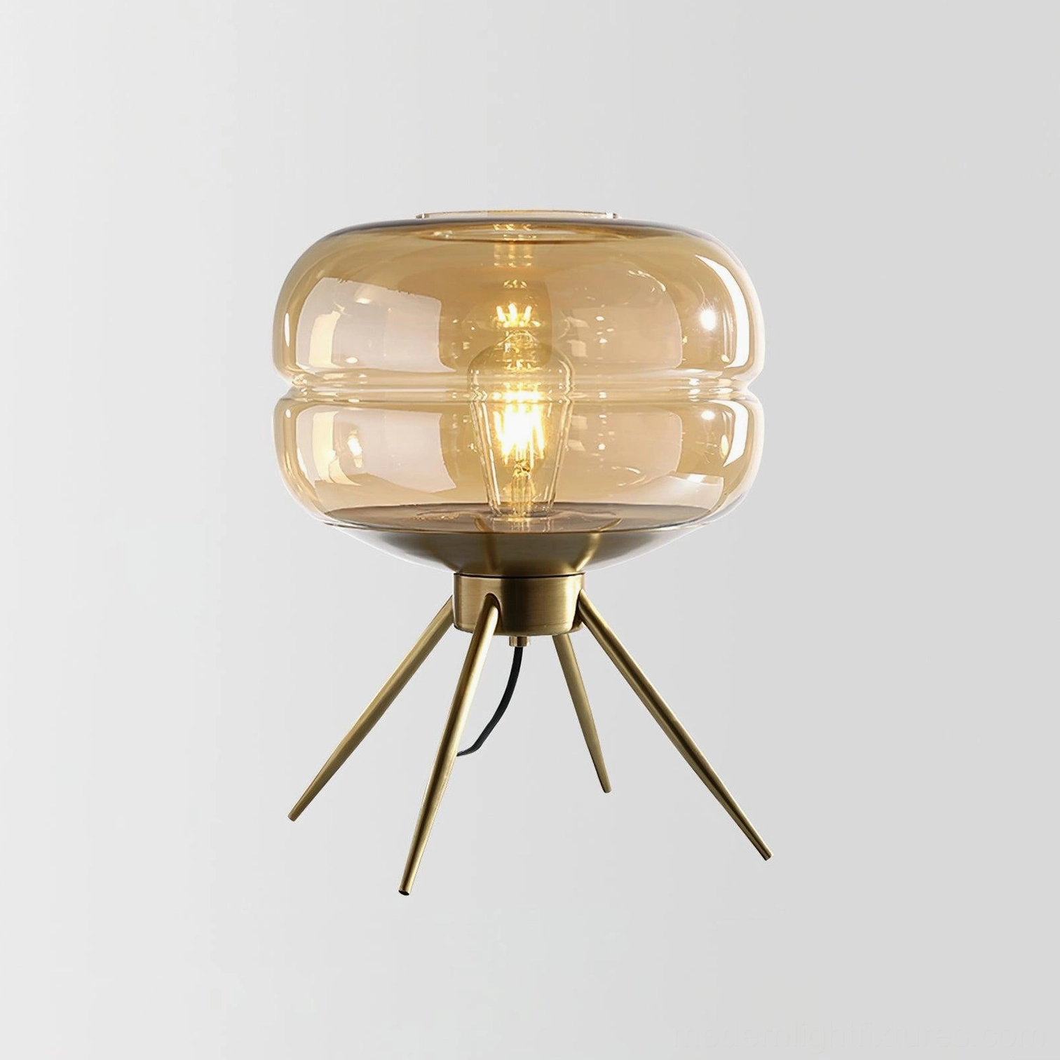 Warm amber tiered glass table lamp with brass base full product view on plain white background