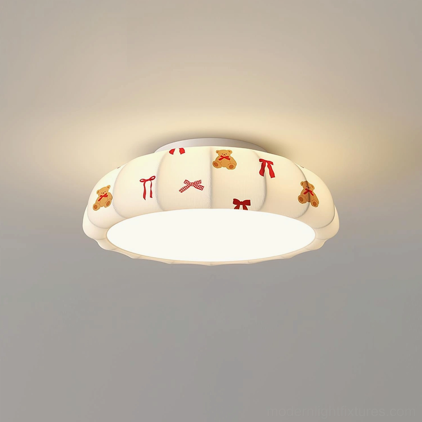 Closeup view of compact Model A pumpkin ceiling fixture with red tone accents and playful bear bow decoration, flush mount design