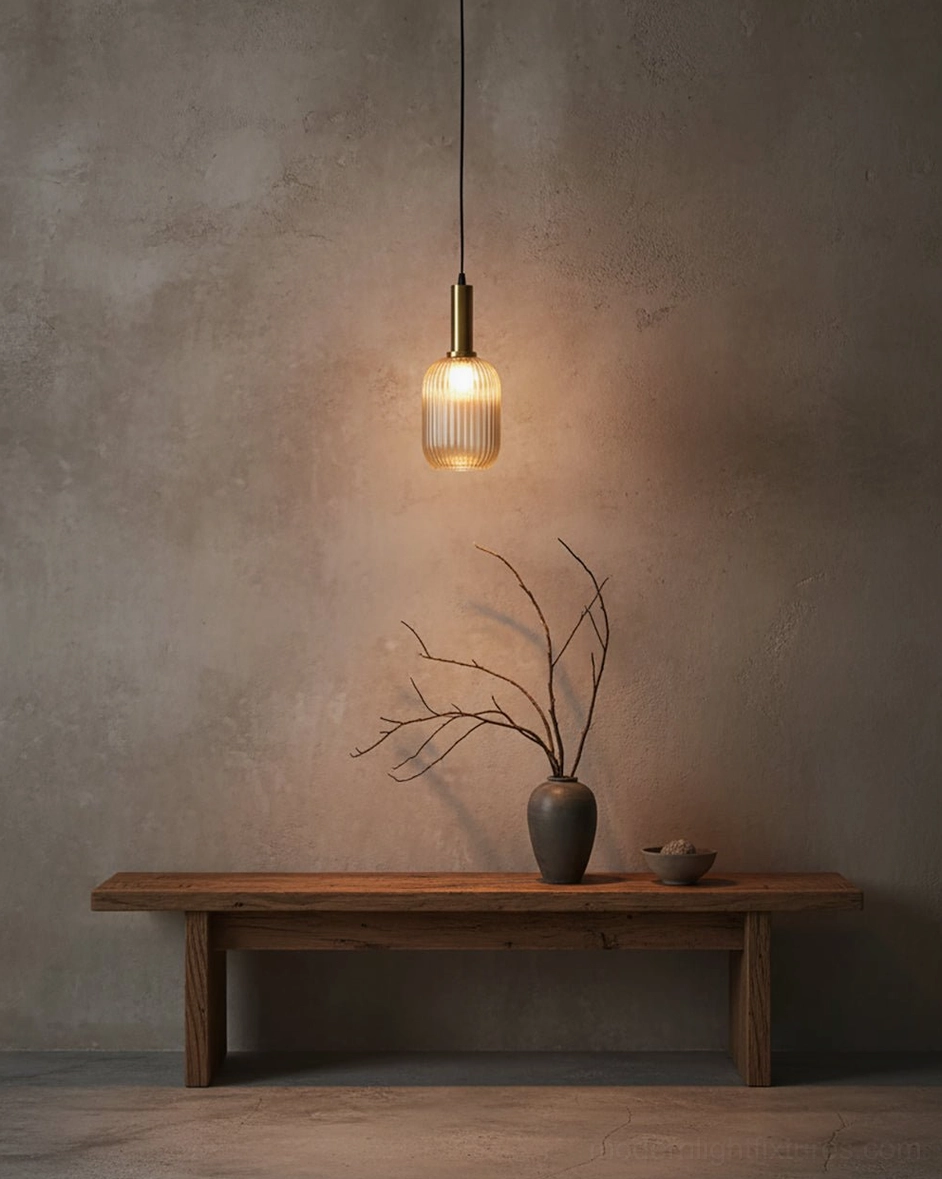 Model B ribbed glass pendant lamp centered above dining table demonstrating ideal height and illumination for meal preparation