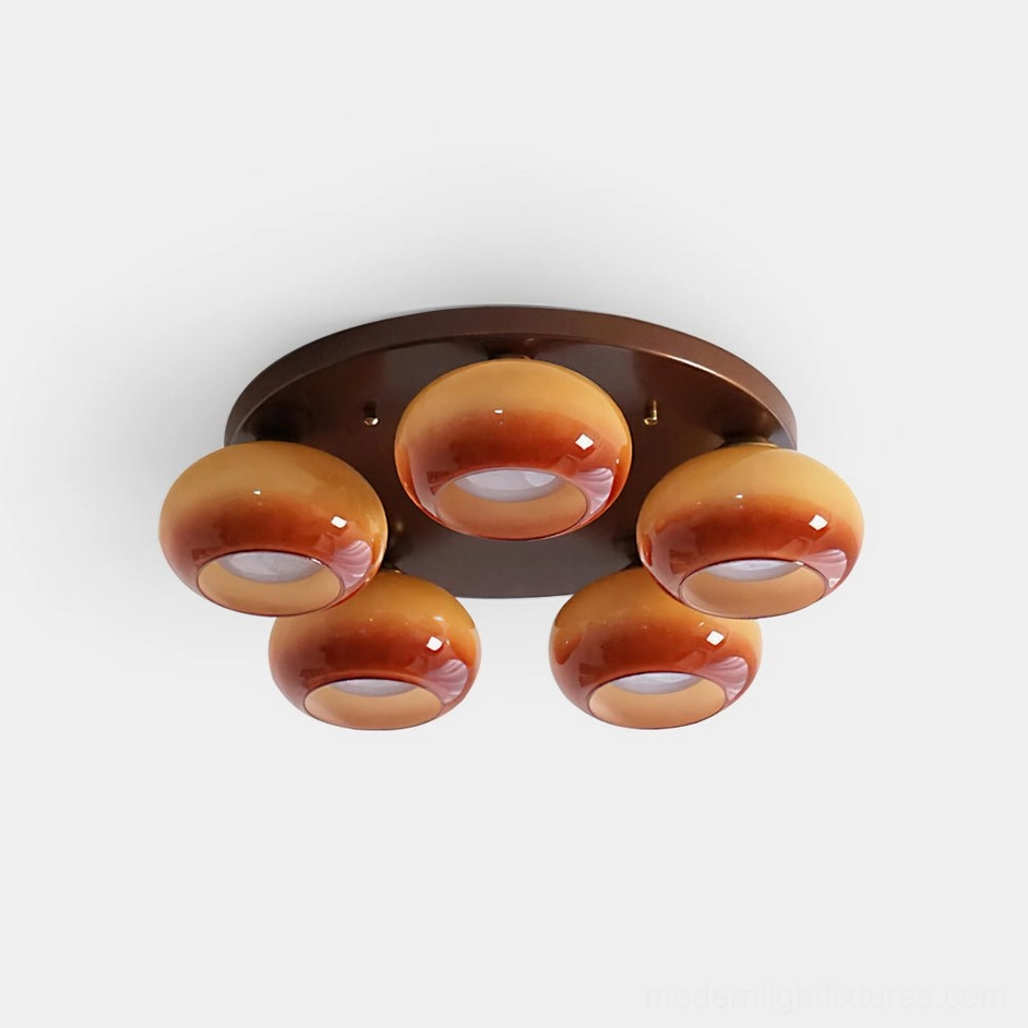 Handblown glass 5-head ceiling light fixture with caramel and brown ombre glass orbs and dark metal base - top view product photography