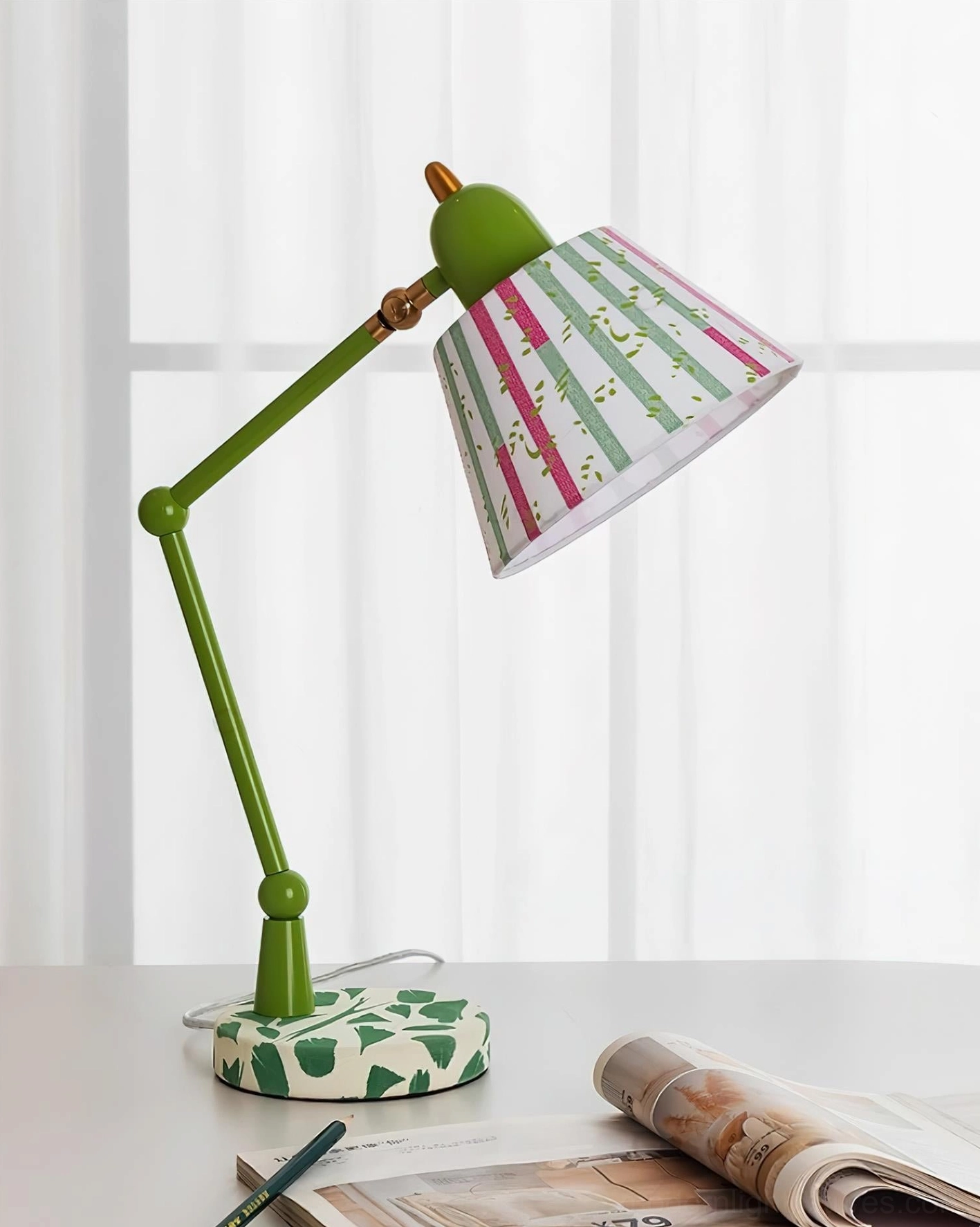 Modern adjustable green table lamp with multi-colored striped lampshade, three-quarter front angle with interior setting