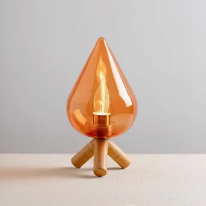 Contemporary amber glass table lamp with three-quarter angle view, showcasing warm LED filament glow and natural wood grain finish