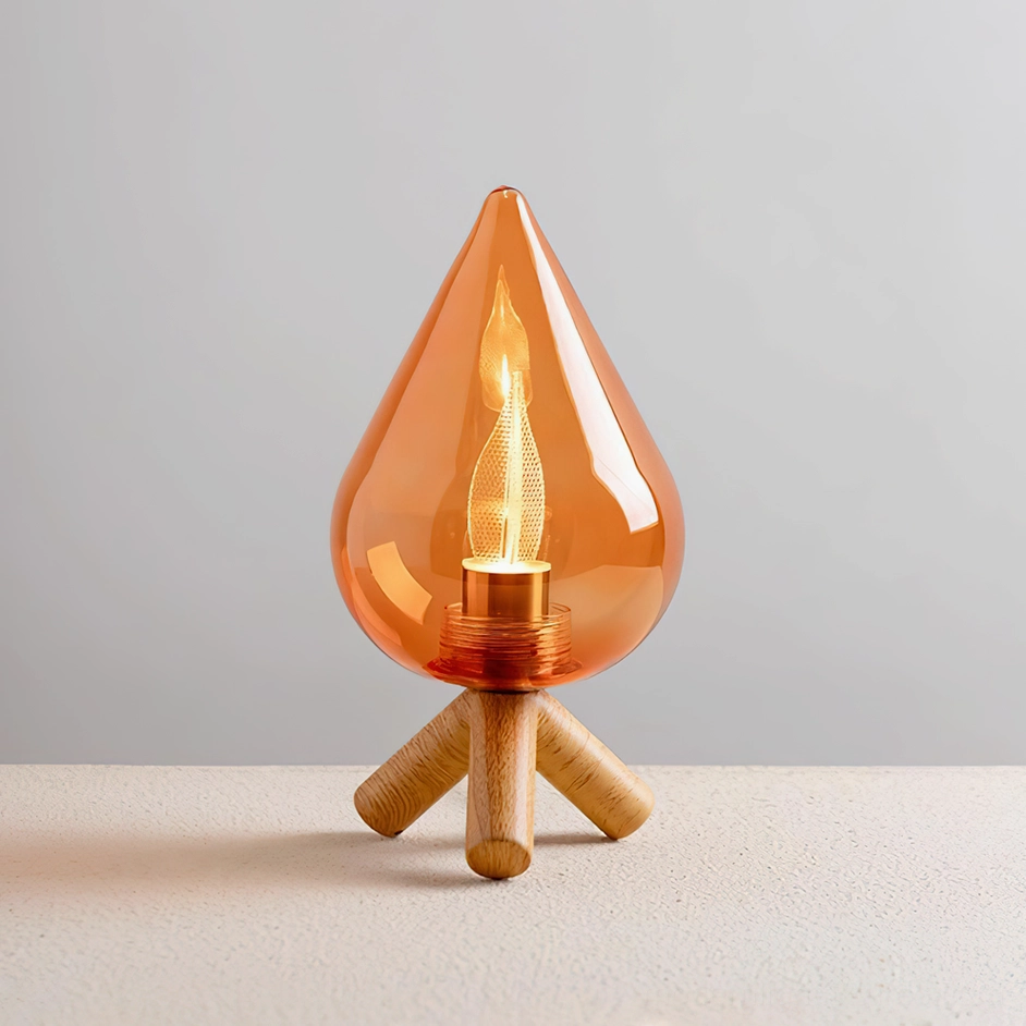 Contemporary amber glass table lamp with three-quarter angle view, showcasing warm LED filament glow and natural wood grain finish