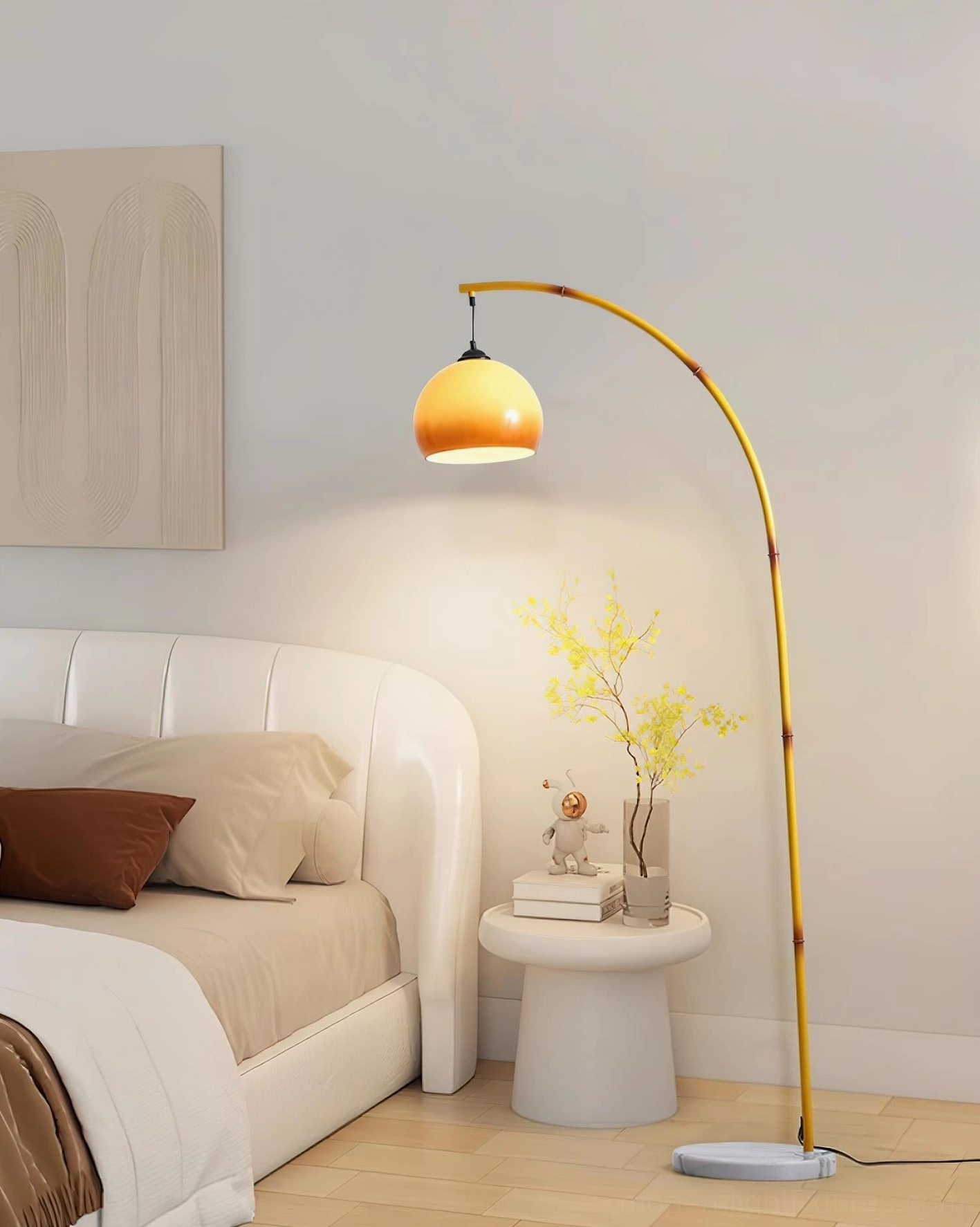 Arc floor lamp with yellow curved metal frame in modern bedroom setting with bed and minimal décor