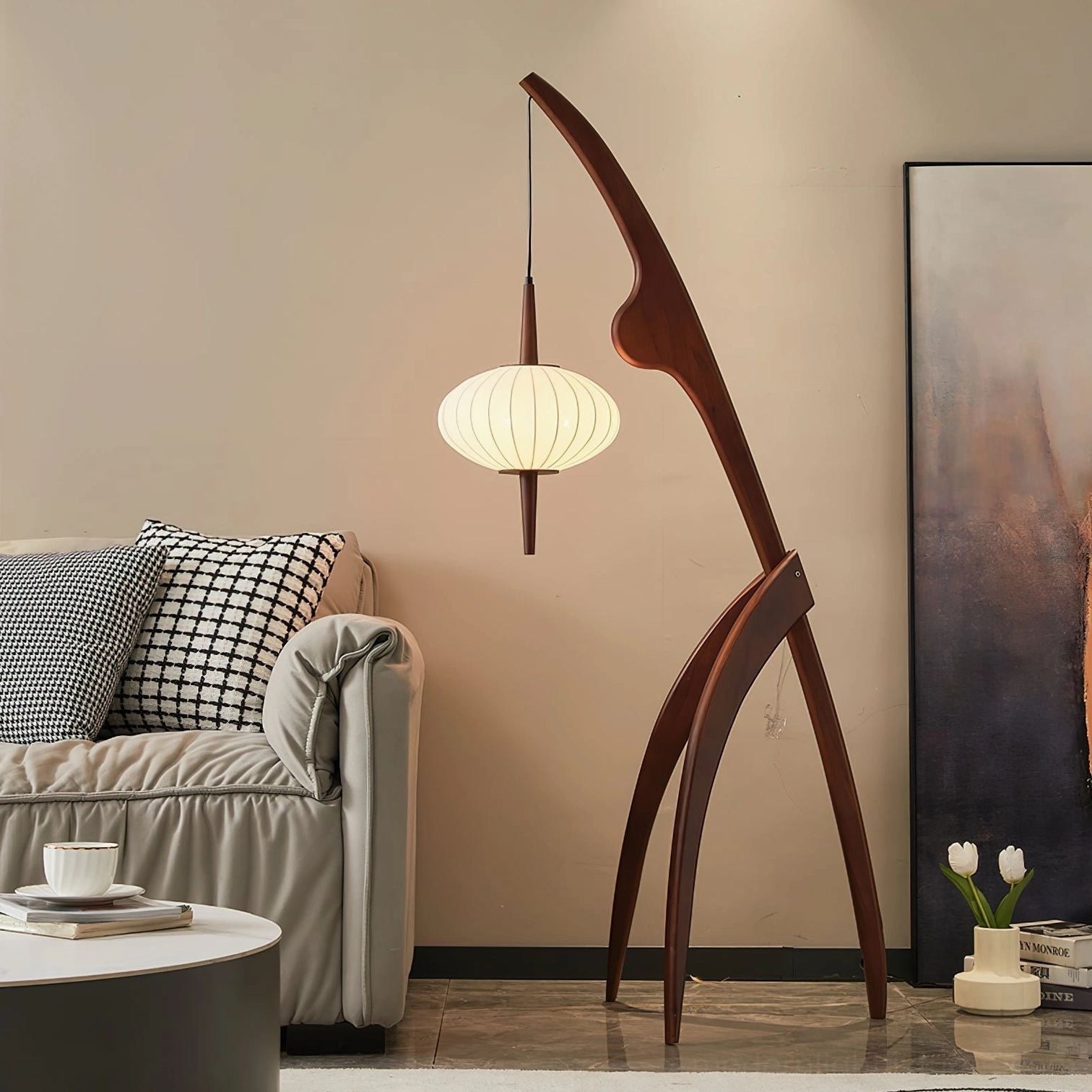 Arc floor lamp with curved wooden stand and minimalist fabric lantern in contemporary living room interior