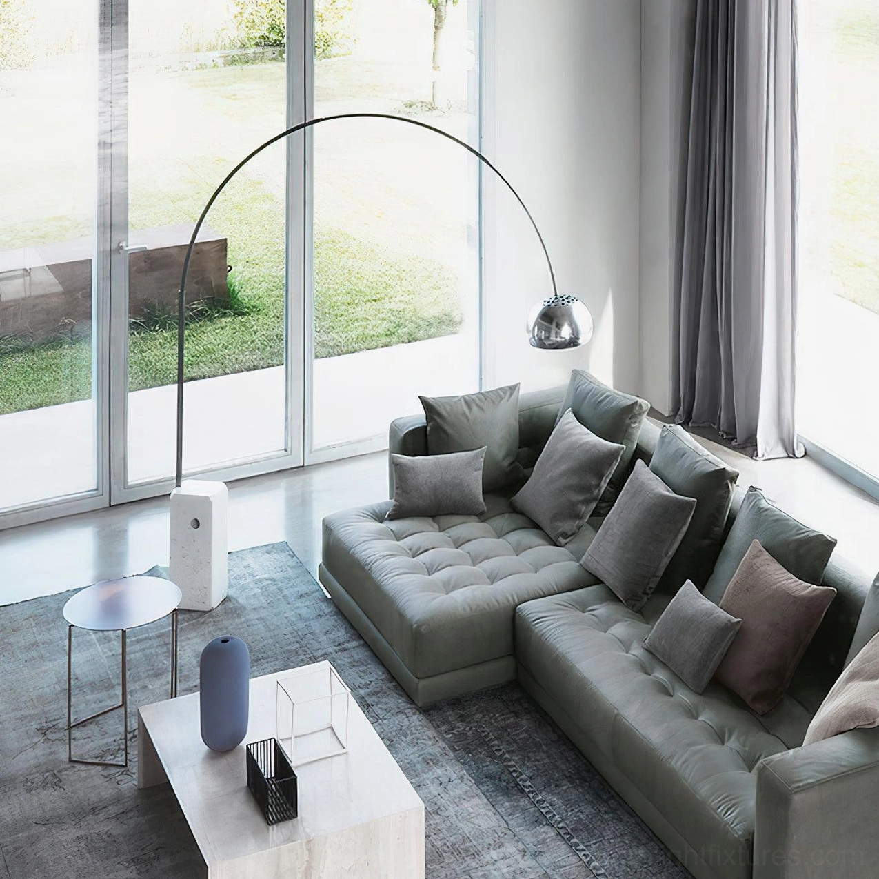 Luxury arc floor lamp in bright living room with sectional sofa and marble base detail