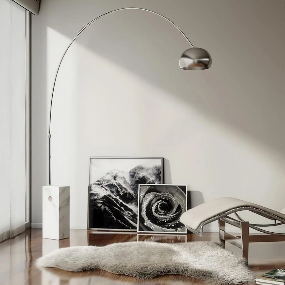 Arc floor lamp with polished silver metal and marble base in neutral modern art interior