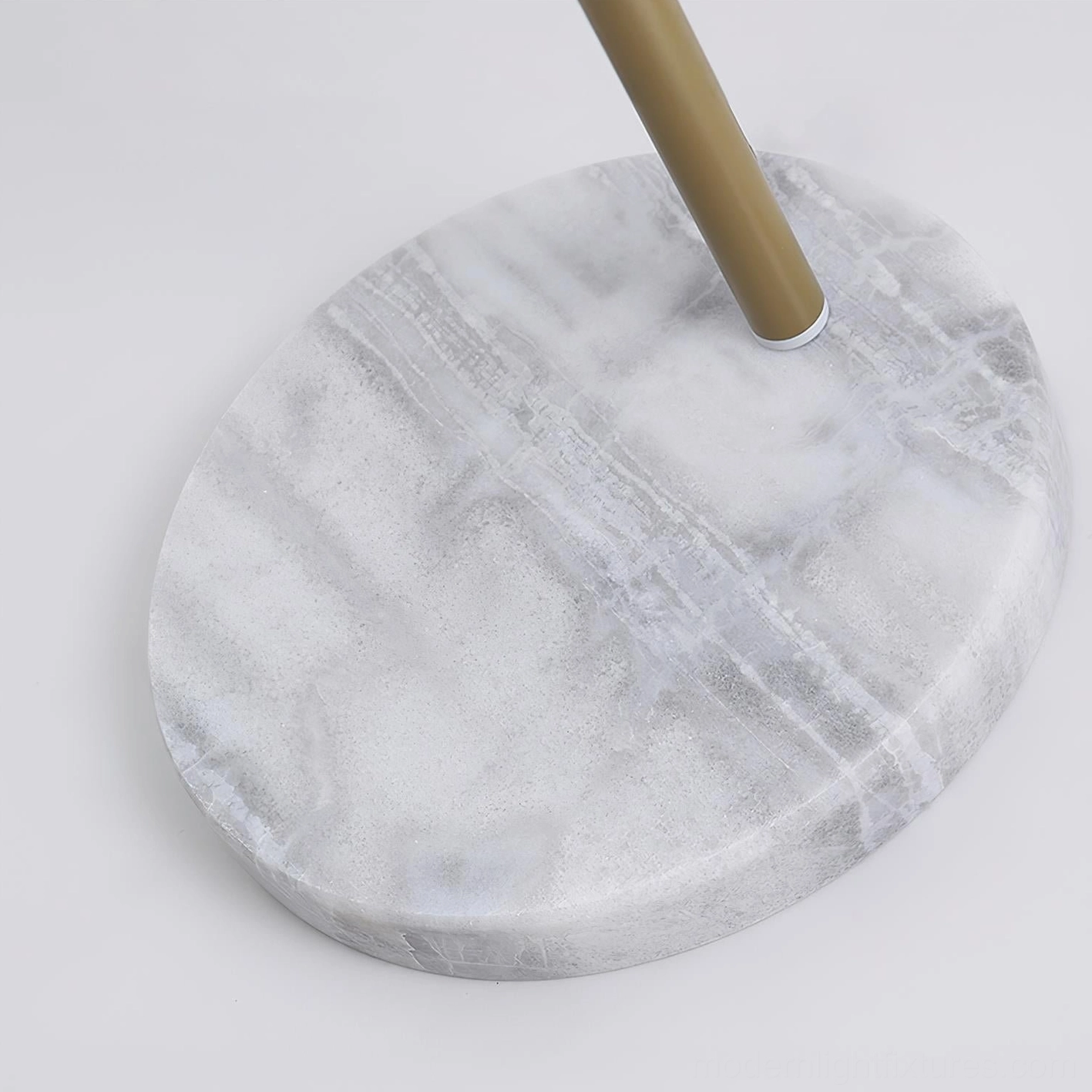 Contemporary yellow arc floor lamp with white marble base demonstrating sculptural design and functional elegance