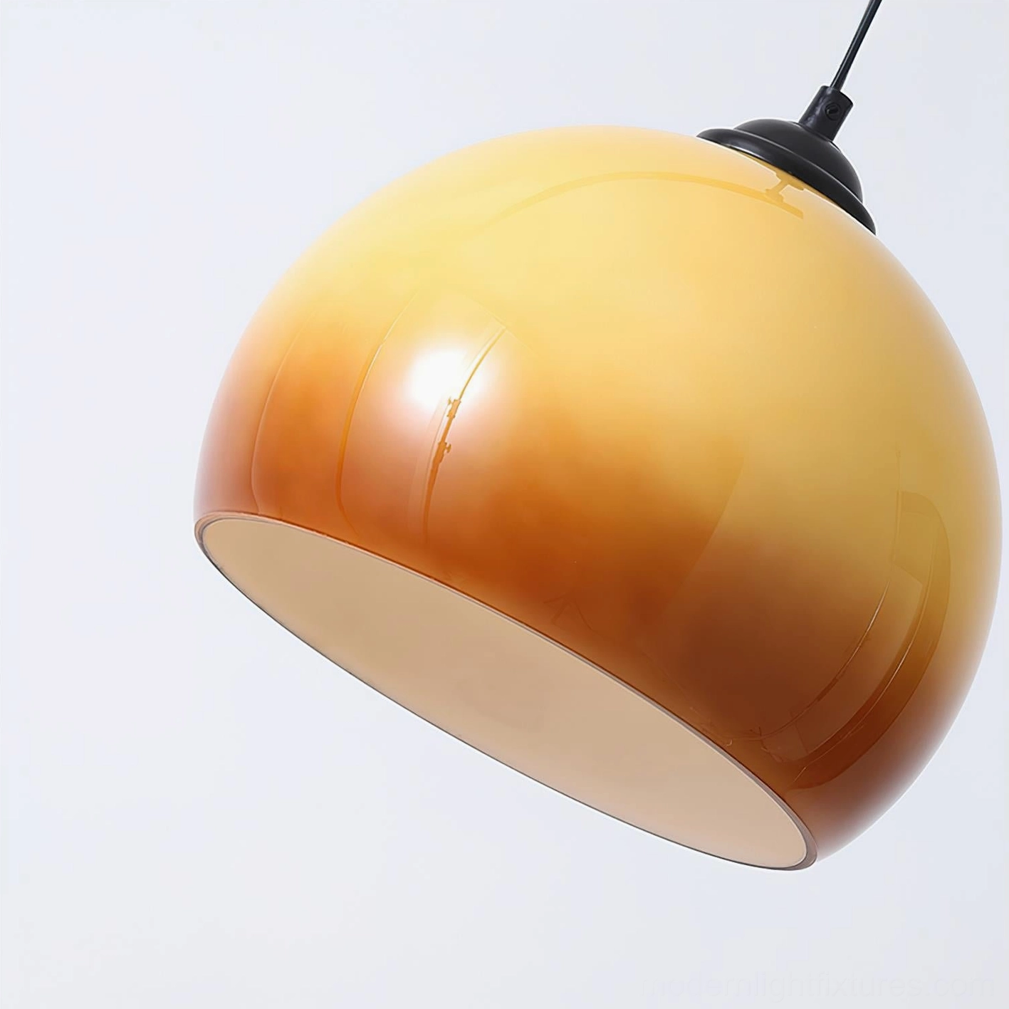 Yellow arc floor lamp with soft caramel lighting creating warm ambient glow in minimalist studio environment
