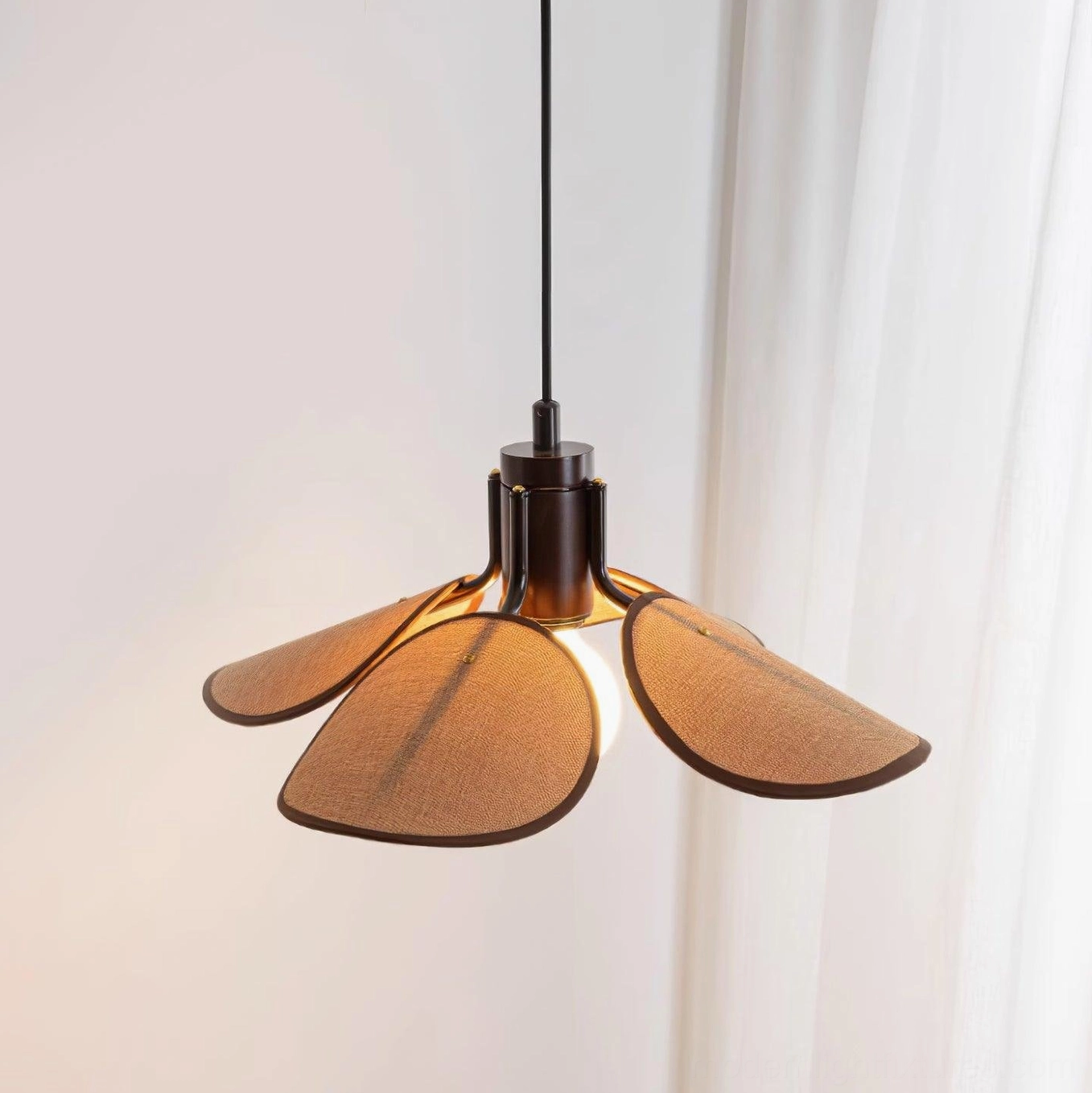 Modern artisan rattan pendant light in coastal style interior with natural wood furniture