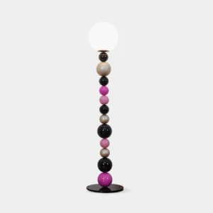 Colorful beaded ball floor lamp with black and pink spheres on white background, modern statement lighting design
