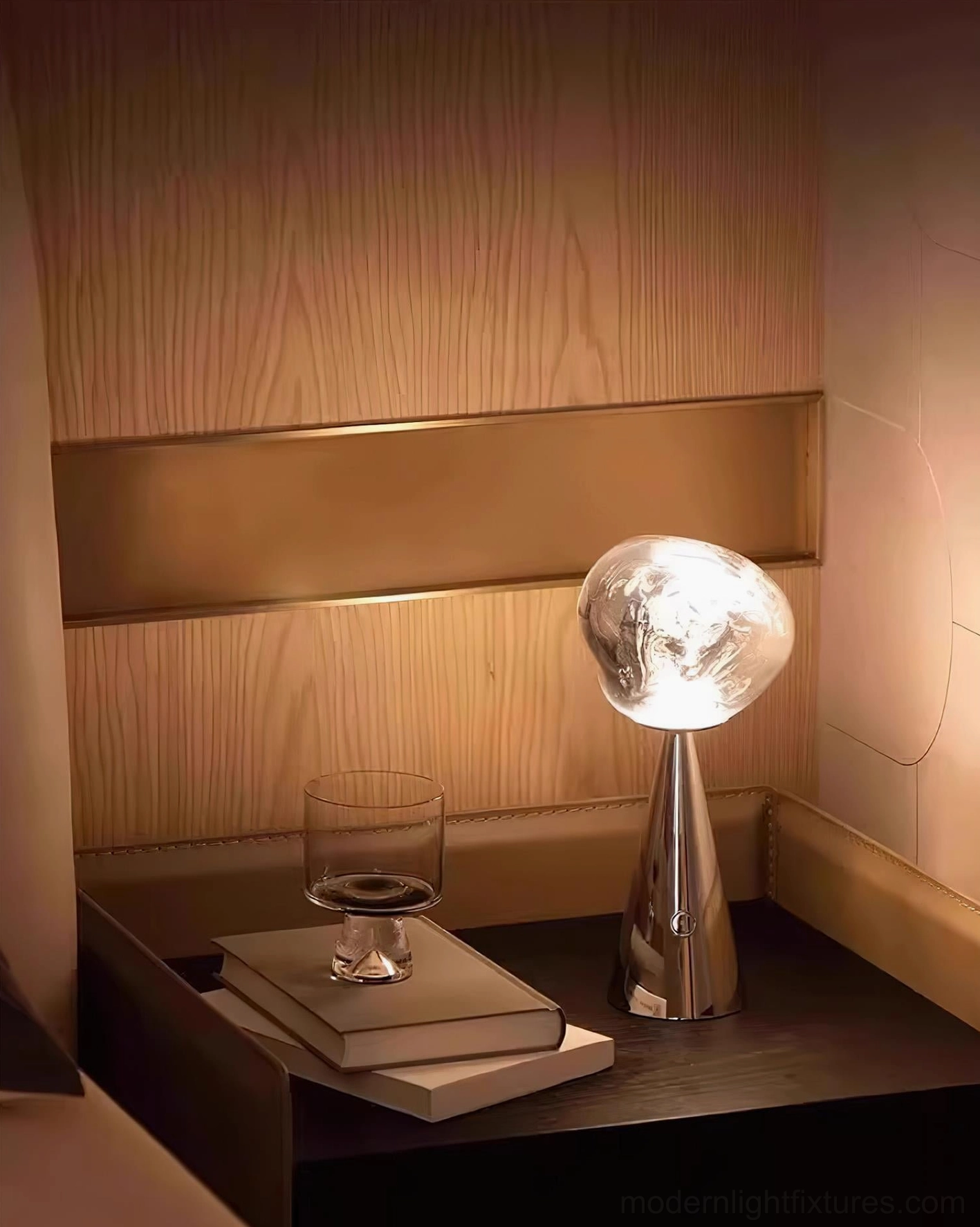 Contemporary bedside table lamp with marbled glass shade in bedroom setting, paired with books and wine glass, warm interior lighting