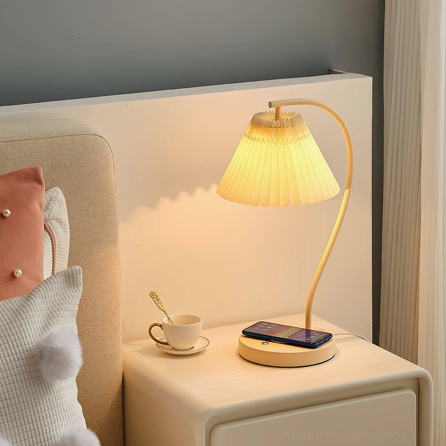 Contemporary pleated bedside lamp emitting warm light on bedroom nightstand