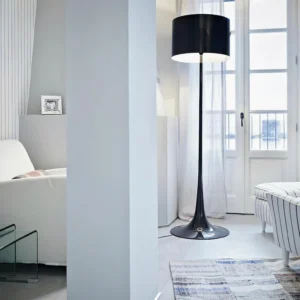 Modern black floor lamp in contemporary living room with balcony view