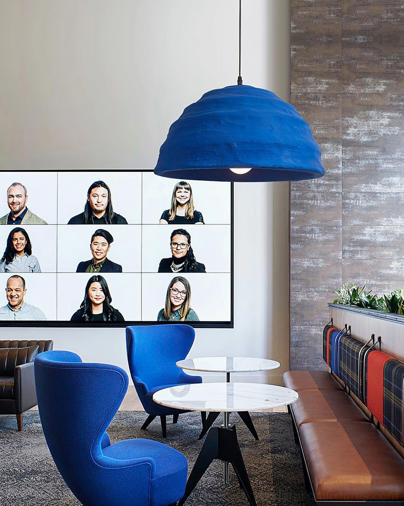 Oblique side angle of blue ribbed dome pendant lamp in modern office lounge with accent seating