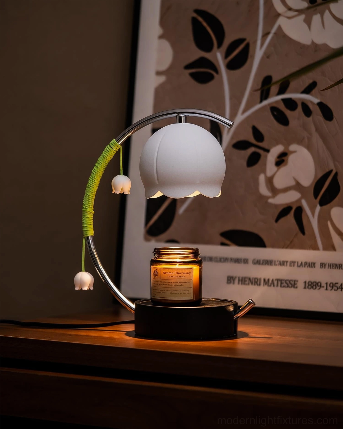 Lily of the Valley Candle Warmer Lamp with lit glass jar candle beside botanical wall art in cozy interior setting